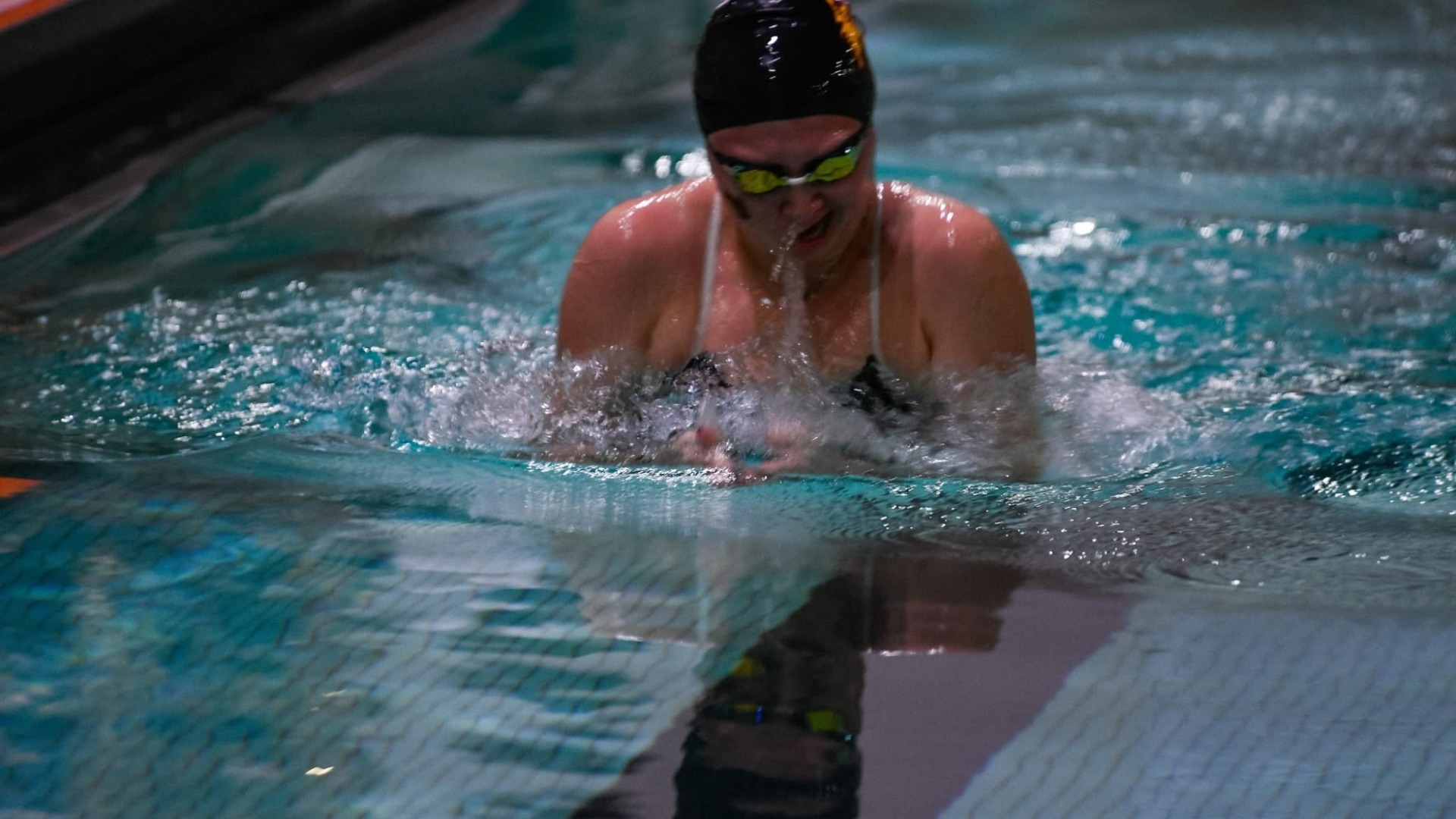 NSU swimmer taking breathes in a swimmer pool where NSU beat Jamestown for their first win of the season.