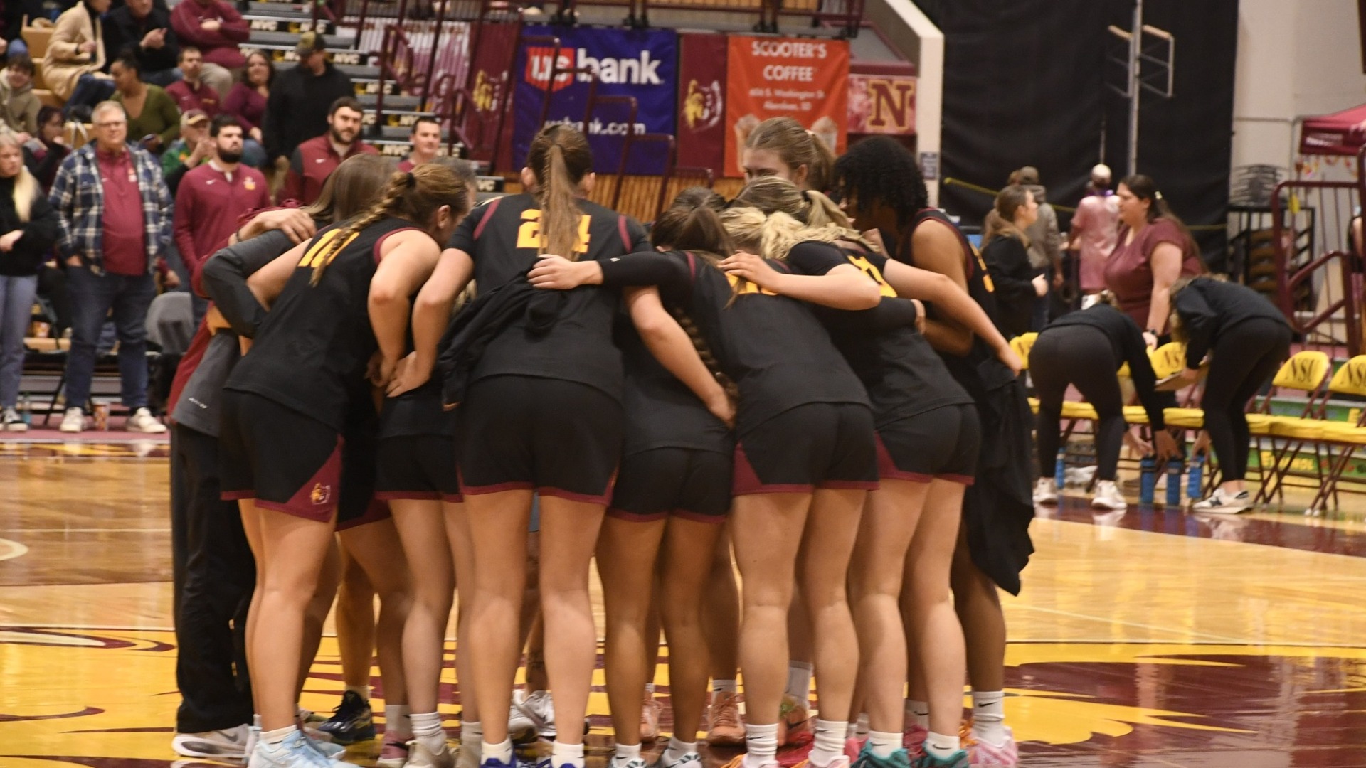 Northern State's team meets in a huddle on the basketball court in the 2025-26 season