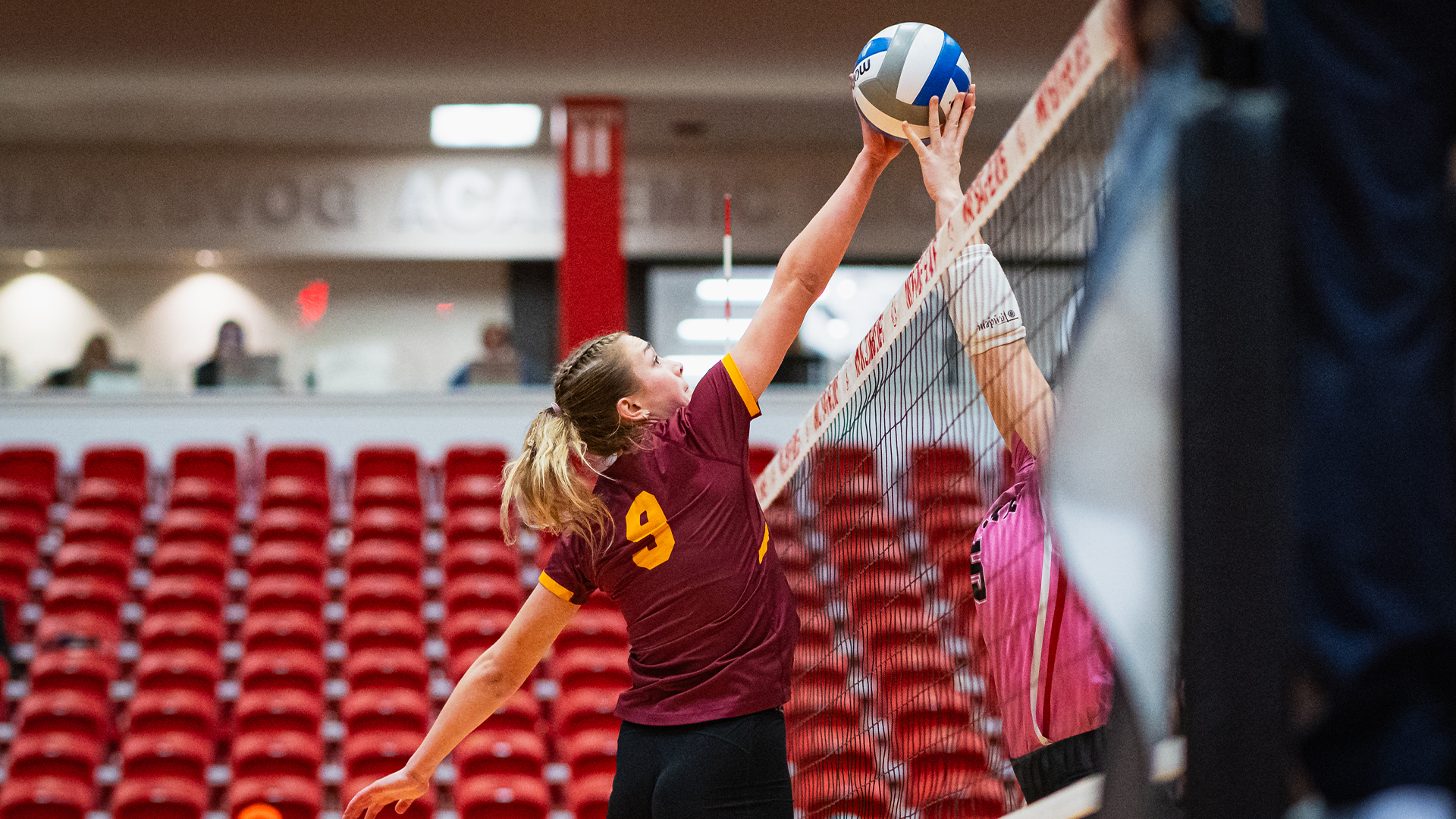 10.27 Volleyball Recap - Ava Nilsson stuffs the ball over the net, pushing it against a Minot State player's hand to win the battle