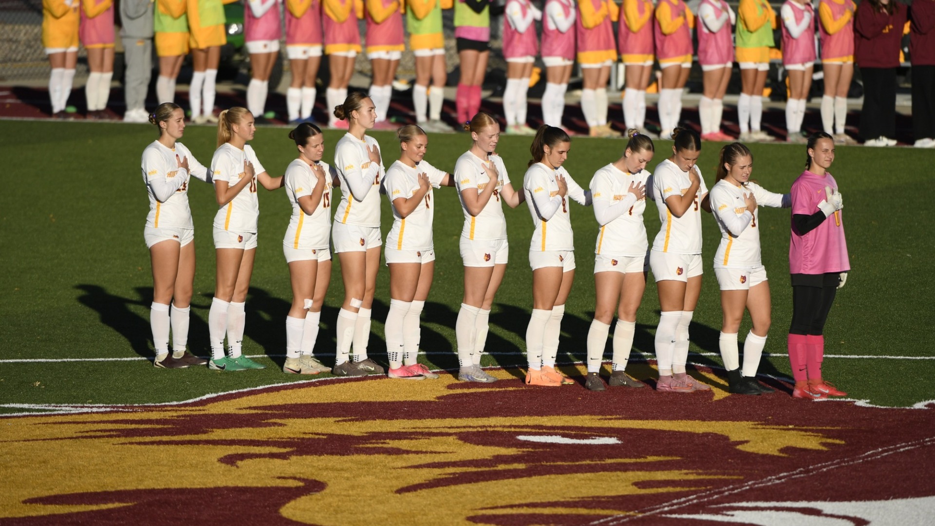 Northern State's starters are standing with their hands over each other's shoulders during the National Anthem in their win against Augustana.