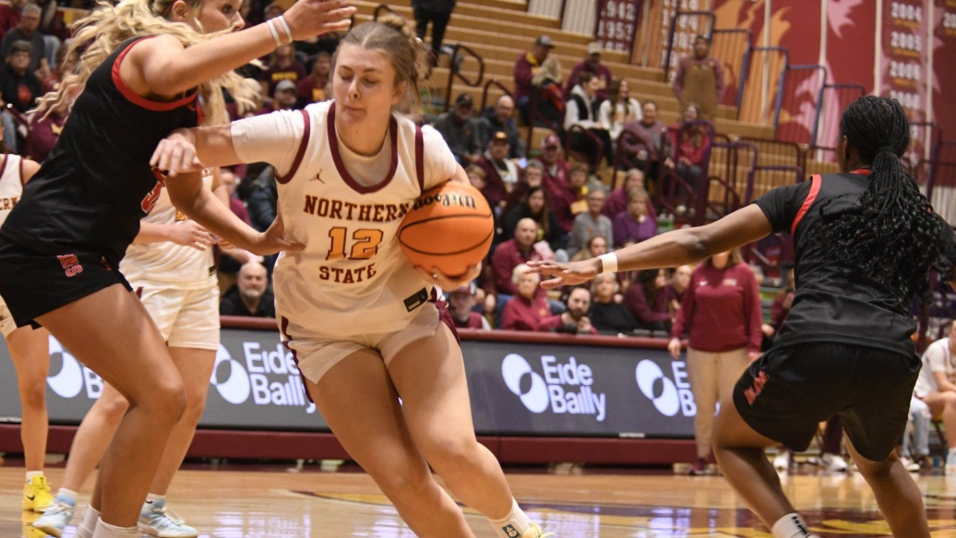 Taylor Tool driving the ball against MSUM defenders.