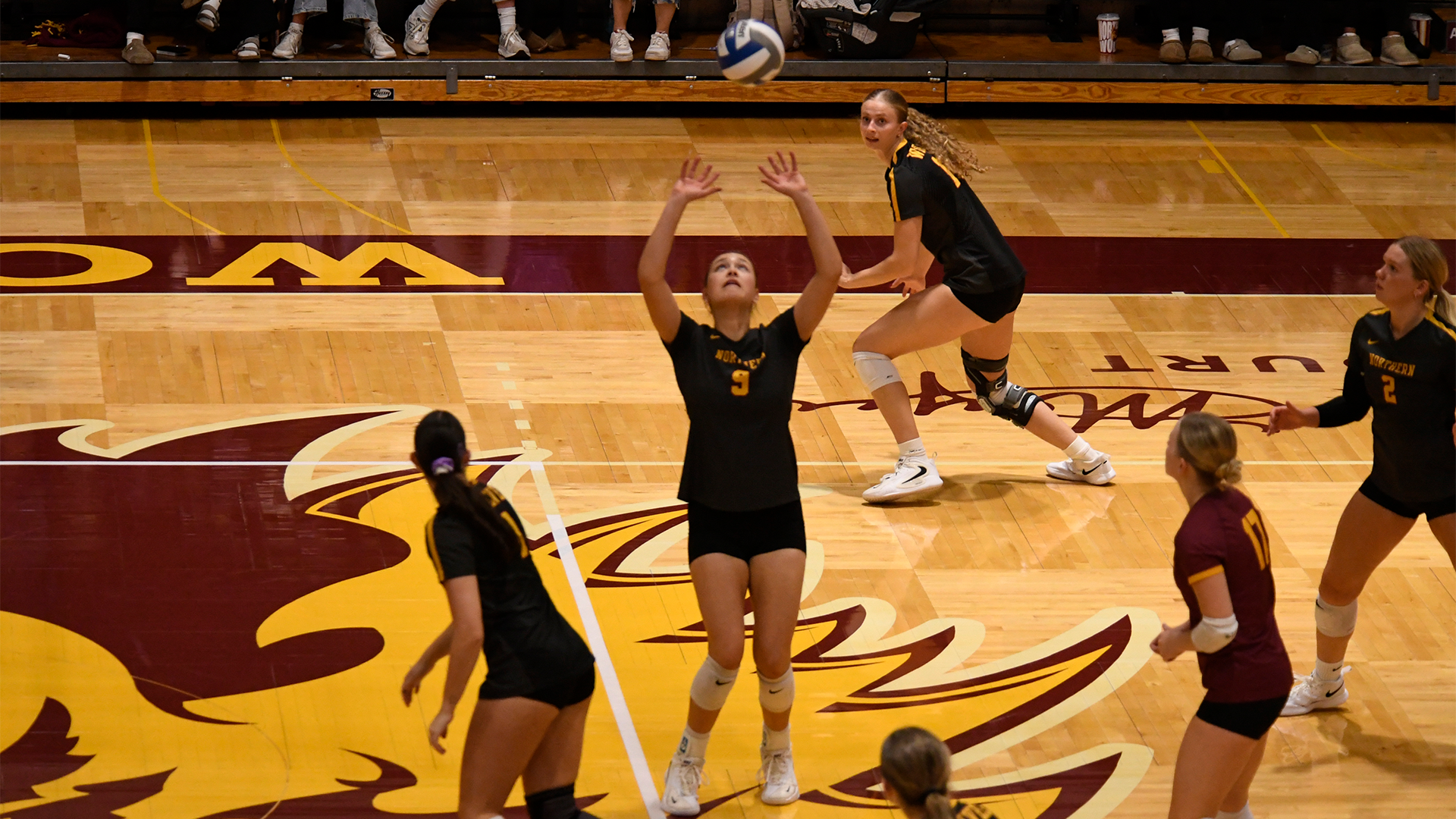 10.7 Volleyball Preview - Ava Nilsson mid-set as her teammates watch on