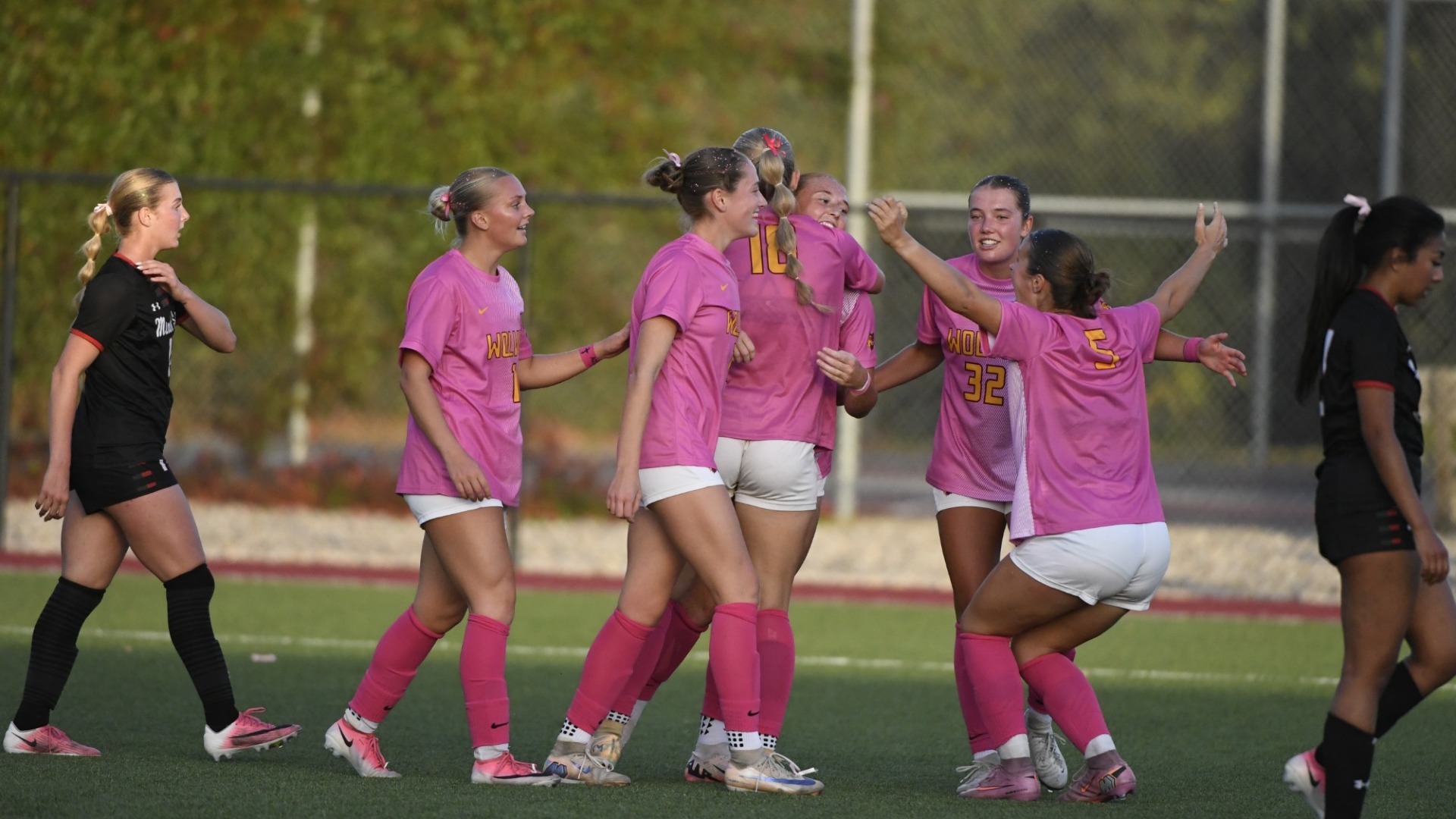 NSU players hugging Sydney Gilbertson after she gave NSU the lead in their 2-0 victory over MiSU.