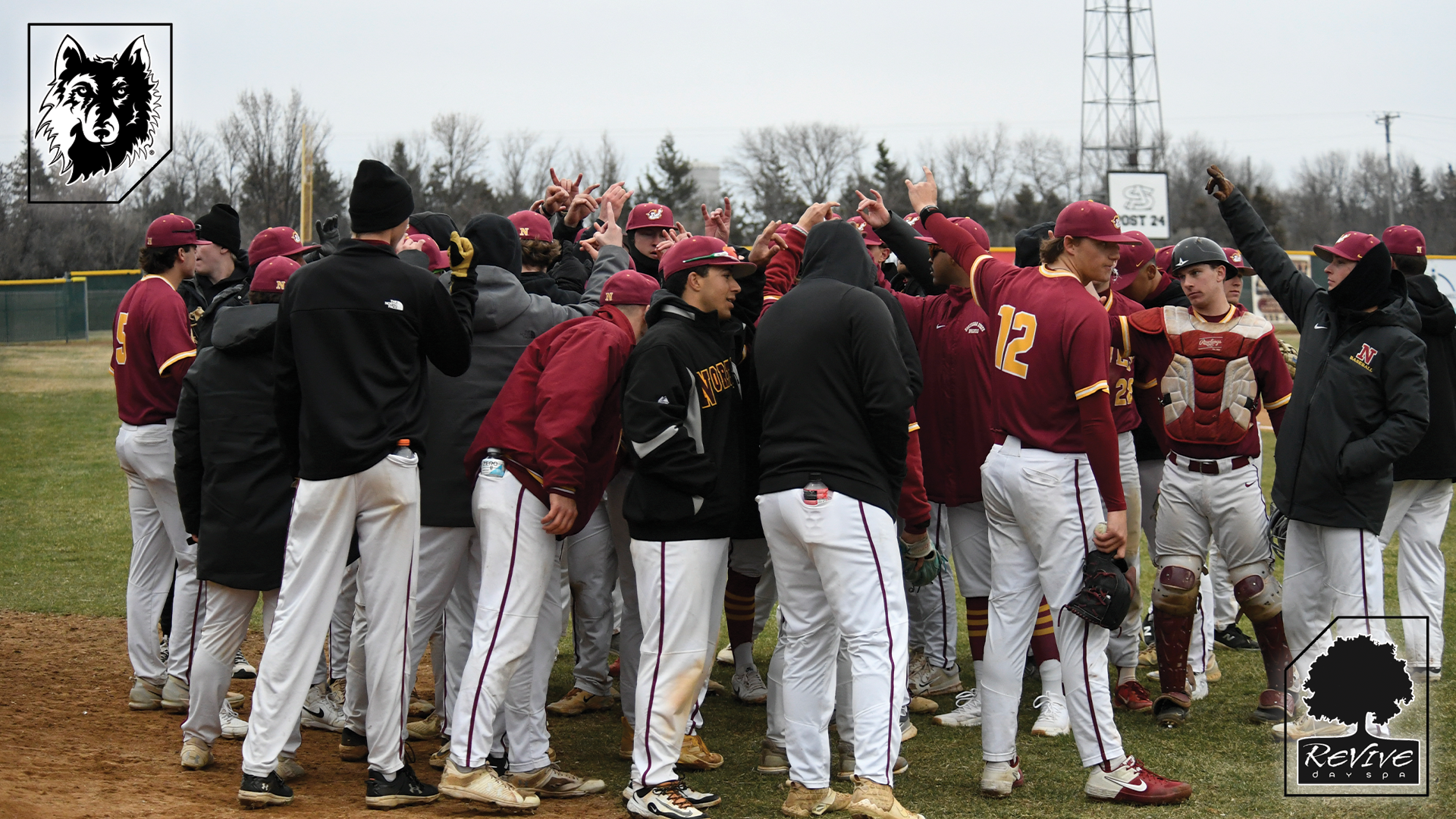 Baseball team huddles up before game against Augustana