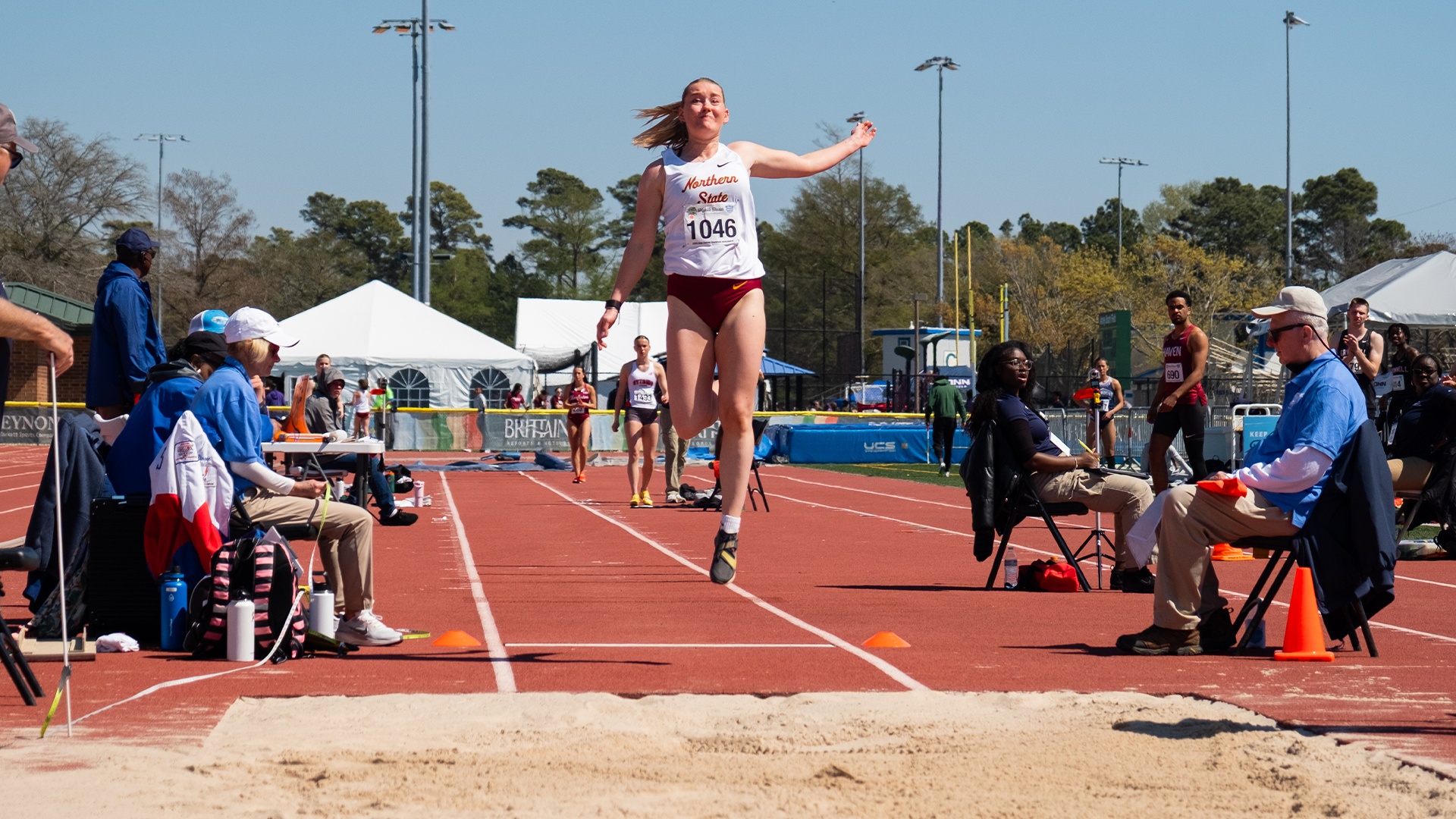 Kamryn Schwartz takes flight as she jumps into sand pit at Alan Connie Shamrock Invite