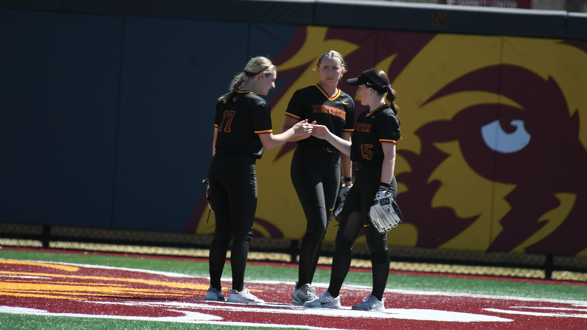 Kinsley Stover (left), Hailey Cota (middle) and Brooke Wolf (right) celebrating in between innings in NSU's 8-5 victory over Bemidji State.