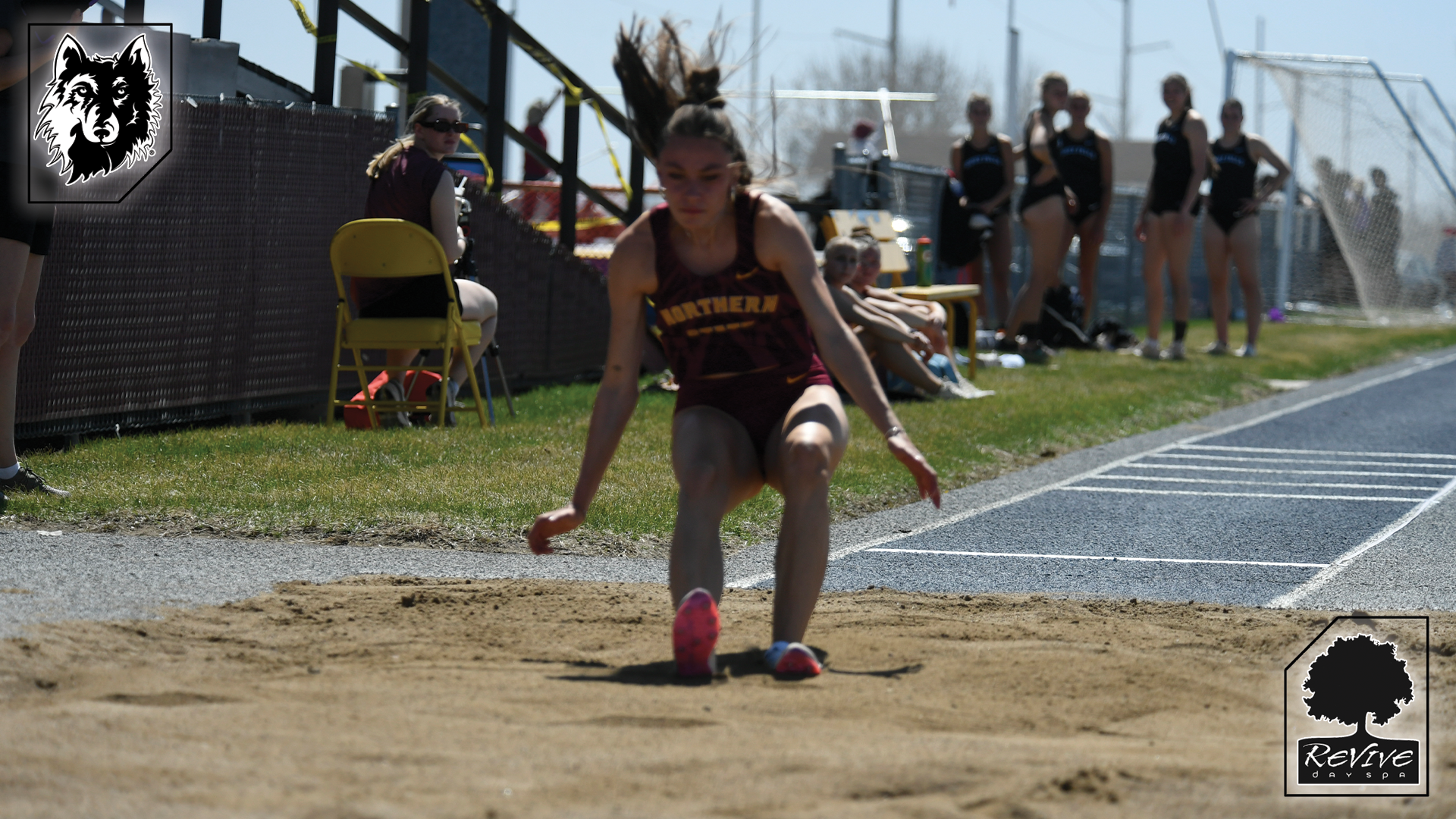 Alexa Fender lands in the sand in the Dewey Donat long jump