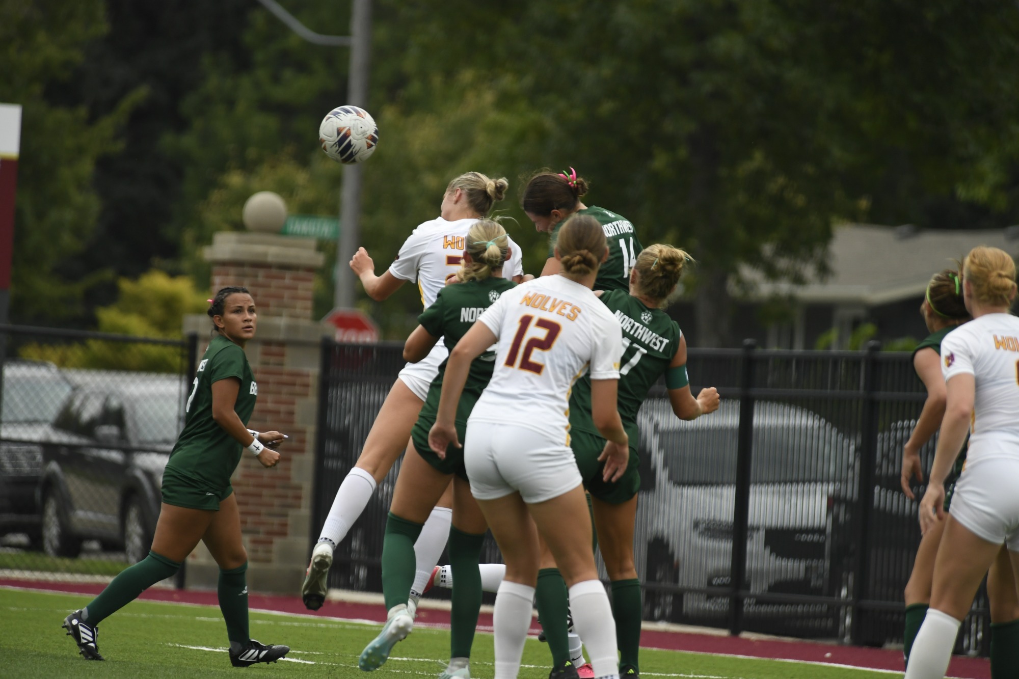 Multiple Wolves and Bearcats jump up to head ball (NSU wolves story cover photo).