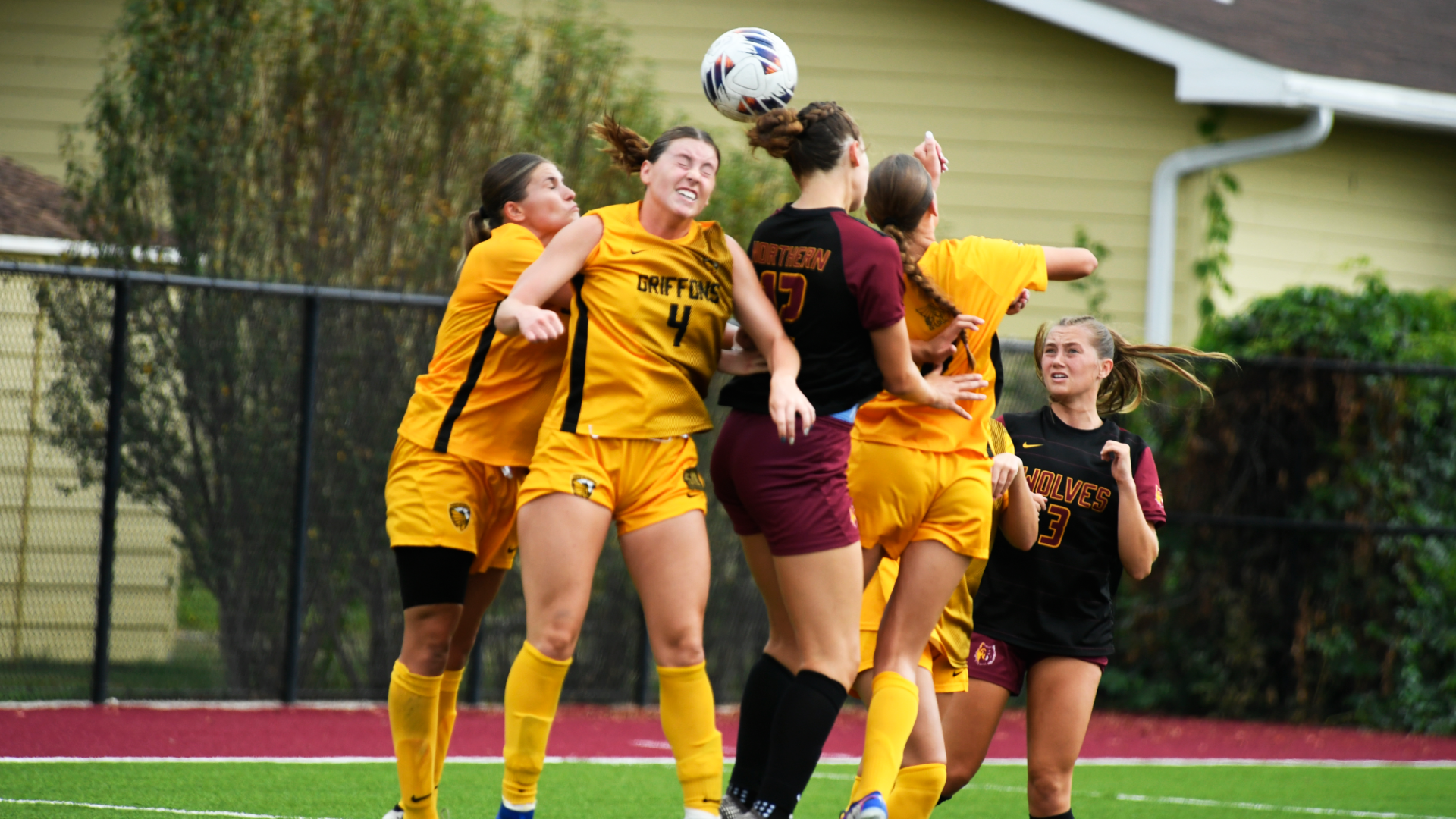 NSU and MWSU athletes jumping up for header before Lauren Youngquist scores goal (assist by Ella Blake).