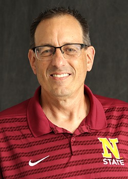 Headshot for Tim Teeter, wearing a maroon polo shirt with the N logo on it. 