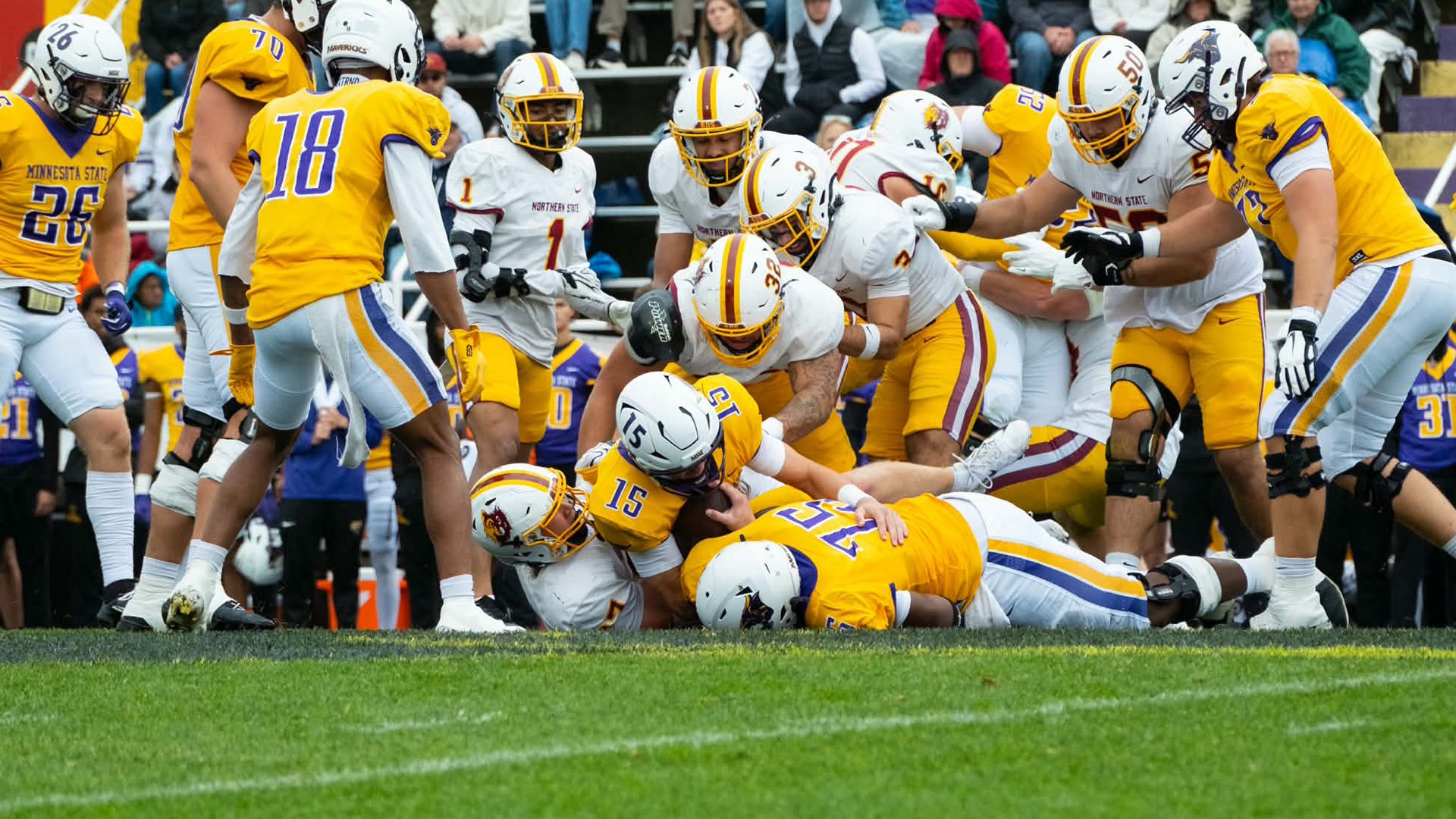 Gabe Gutierrez tackles the MSU quarterback with teammate Andrew Ewald behind and Thomas Risty assisting