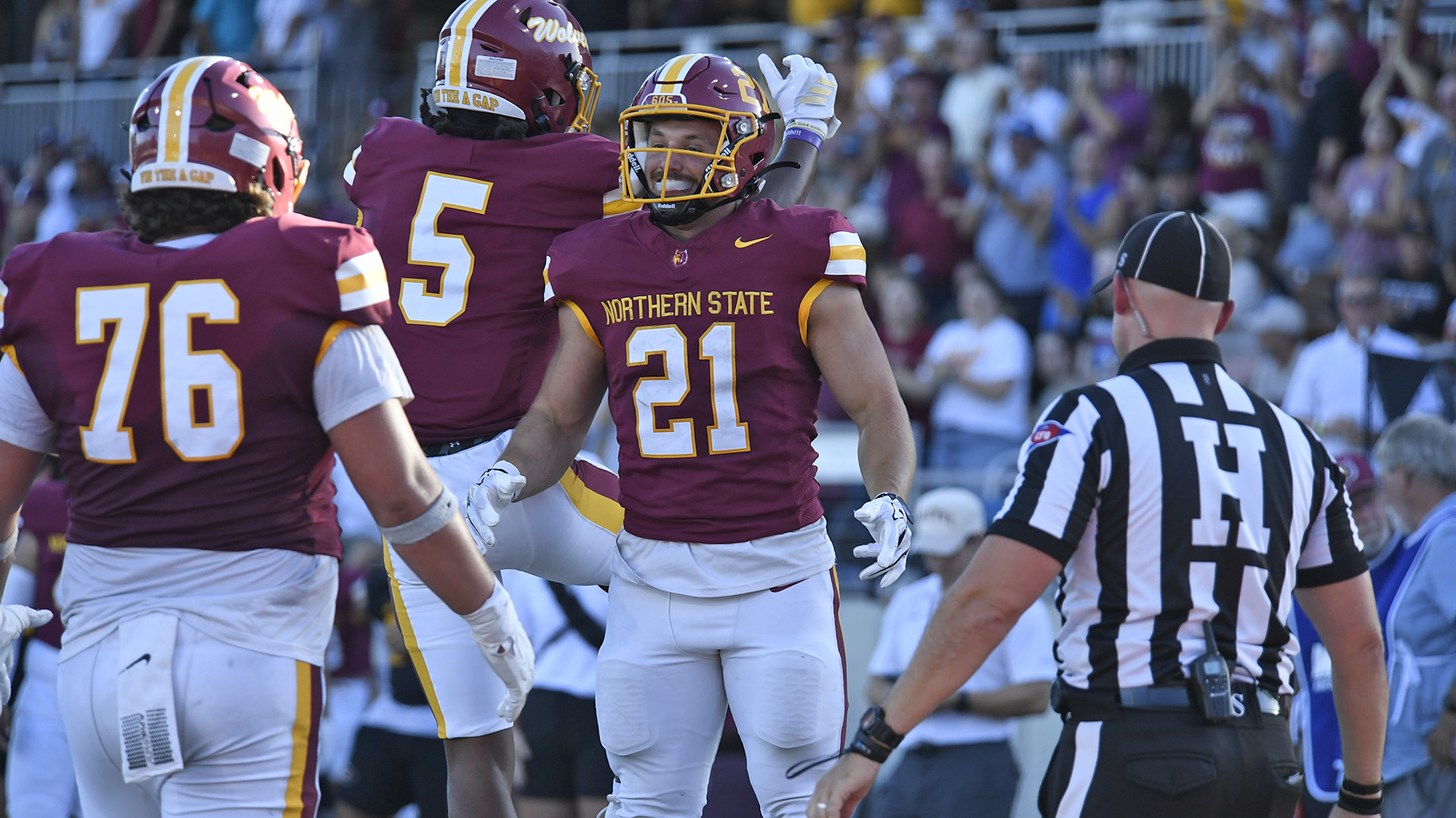 Hank Kraft, Jessie Campbell, and Noah Draeger celebrating a touchdown