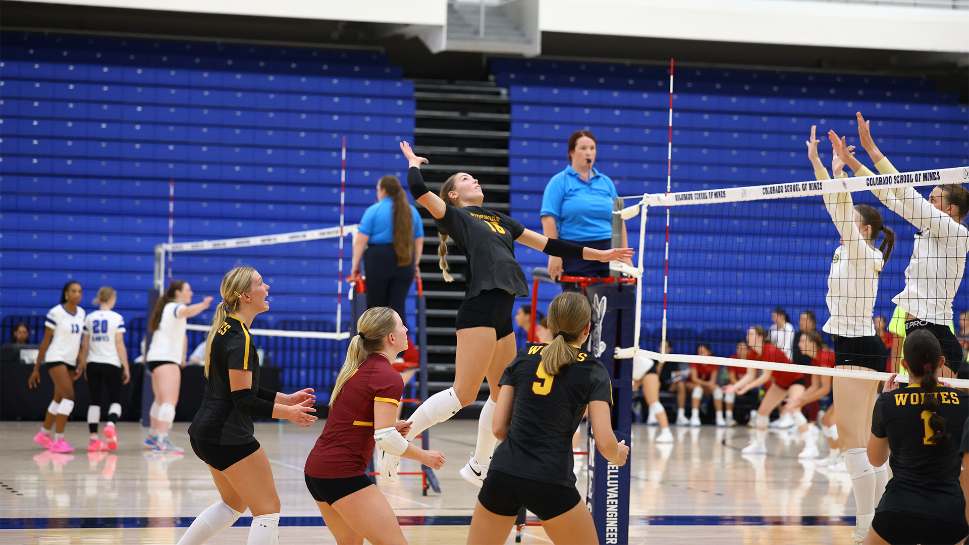Linnea Nesheim skies high for a kill as her teammates look on