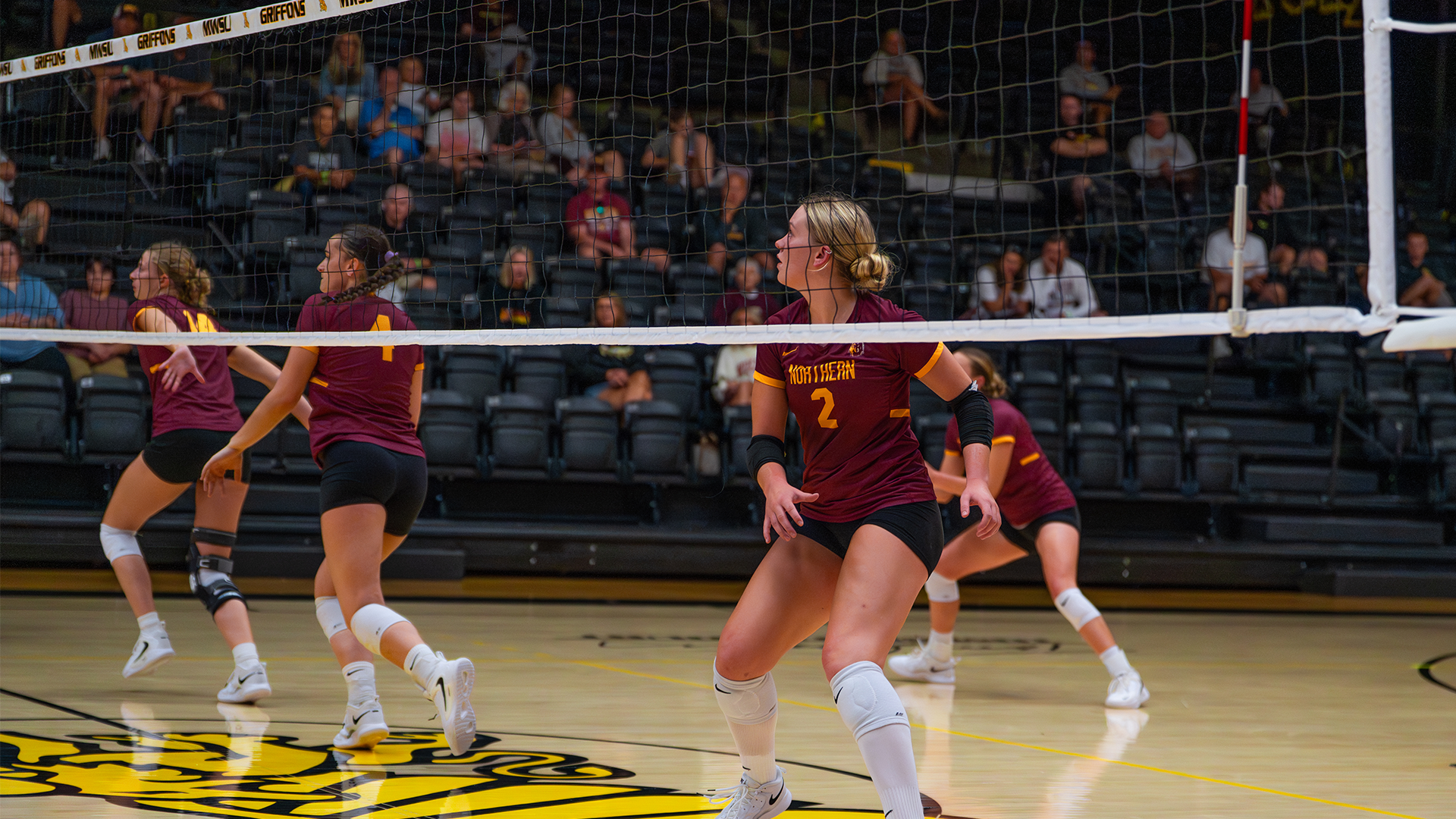 Northern Volleyball's front line of Schroeder, Nelson, and Samuels on the move to jupm for a block