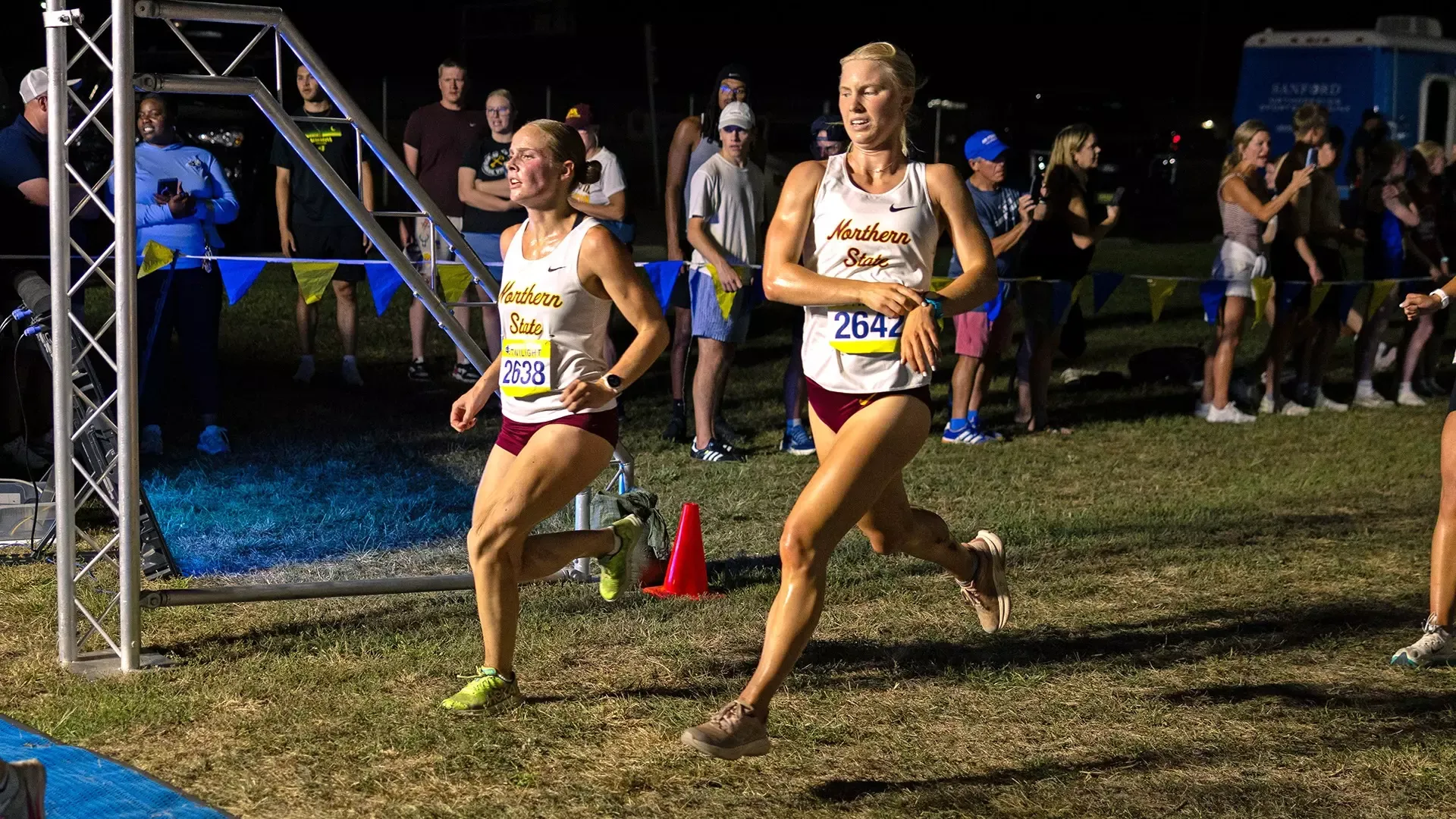 Grace LeClair and Kendal Uttecht crossing the finish line at the AU Twilight