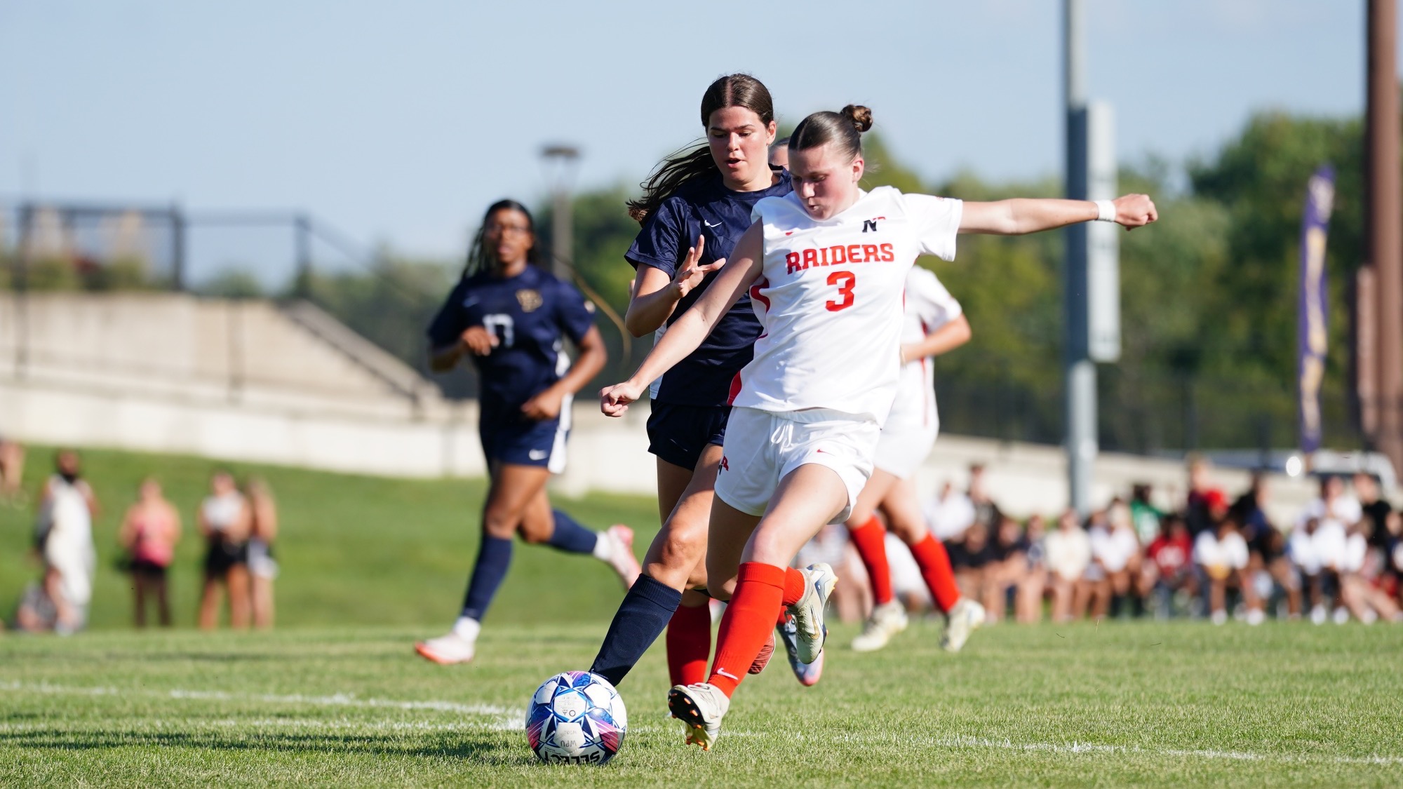 Maddie Anderson moving down field with the ball 