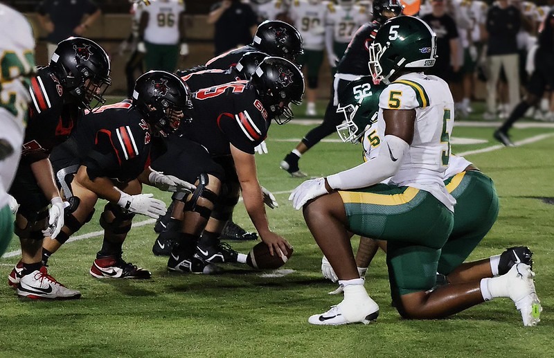Northwestern Football players lined up on the ball before the play