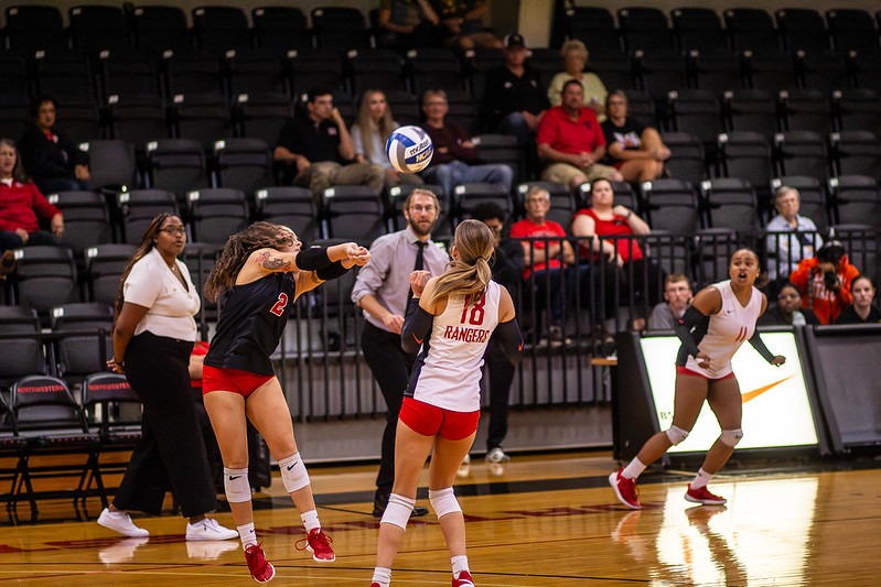 Volleyball Players hitting the ball