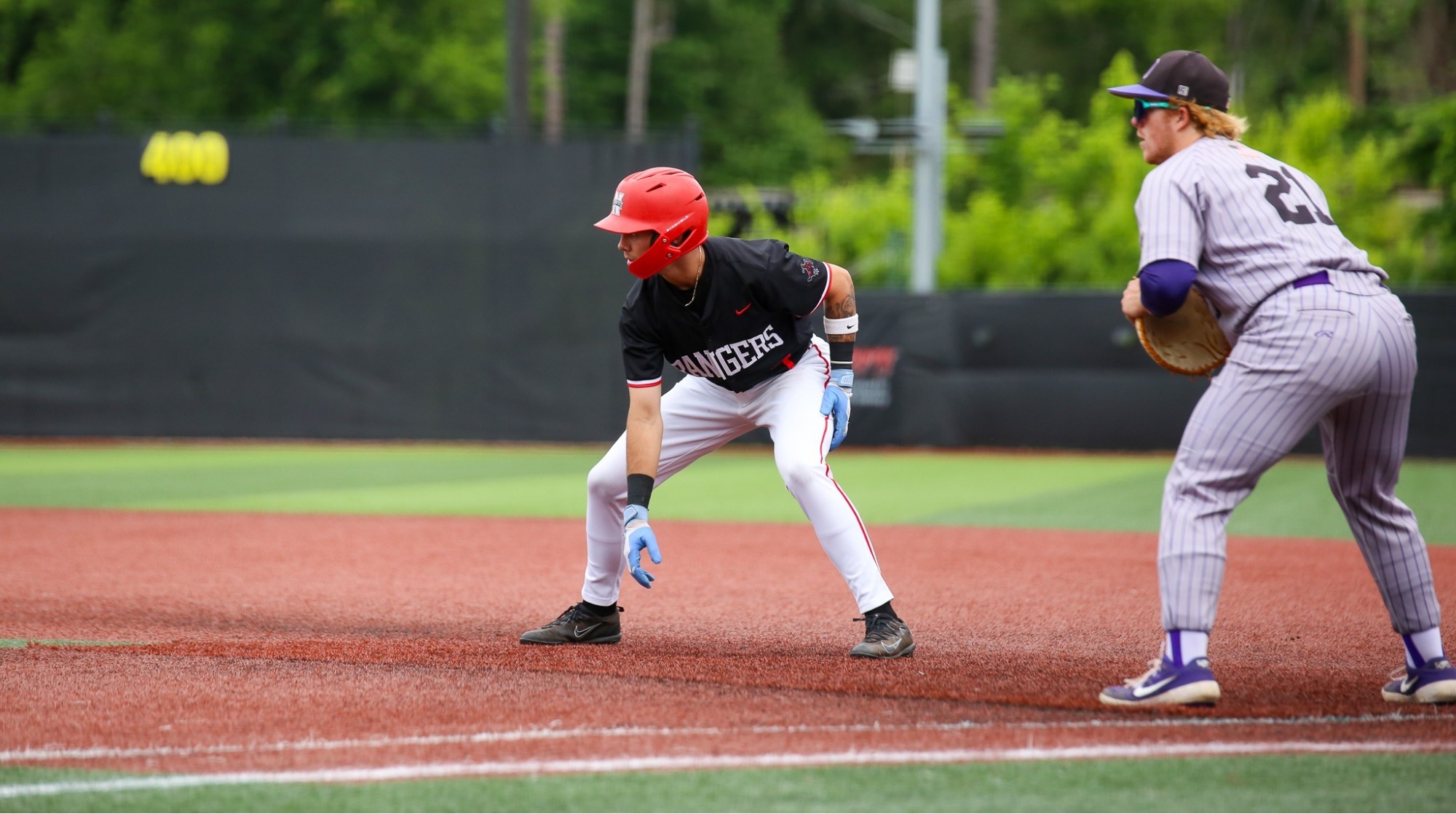 A Ranger baseball player stands on the basepath.