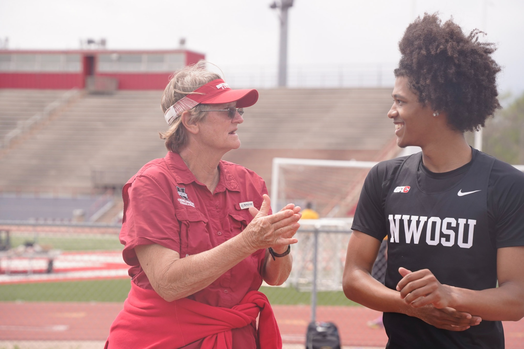 Coach Lancaster speaking with a student-athlete