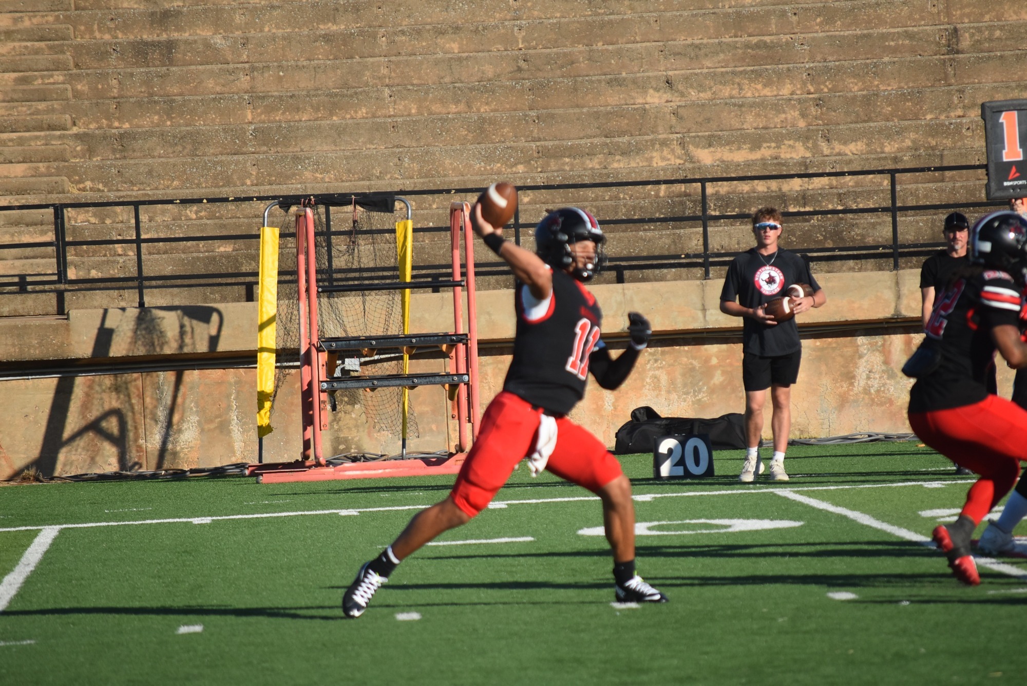 Northwestern football player #11 throwing the ball. 