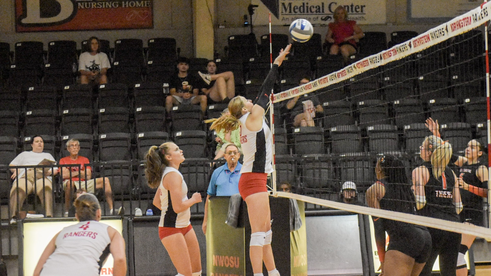 A Northwestern volleyball player spikes the ball