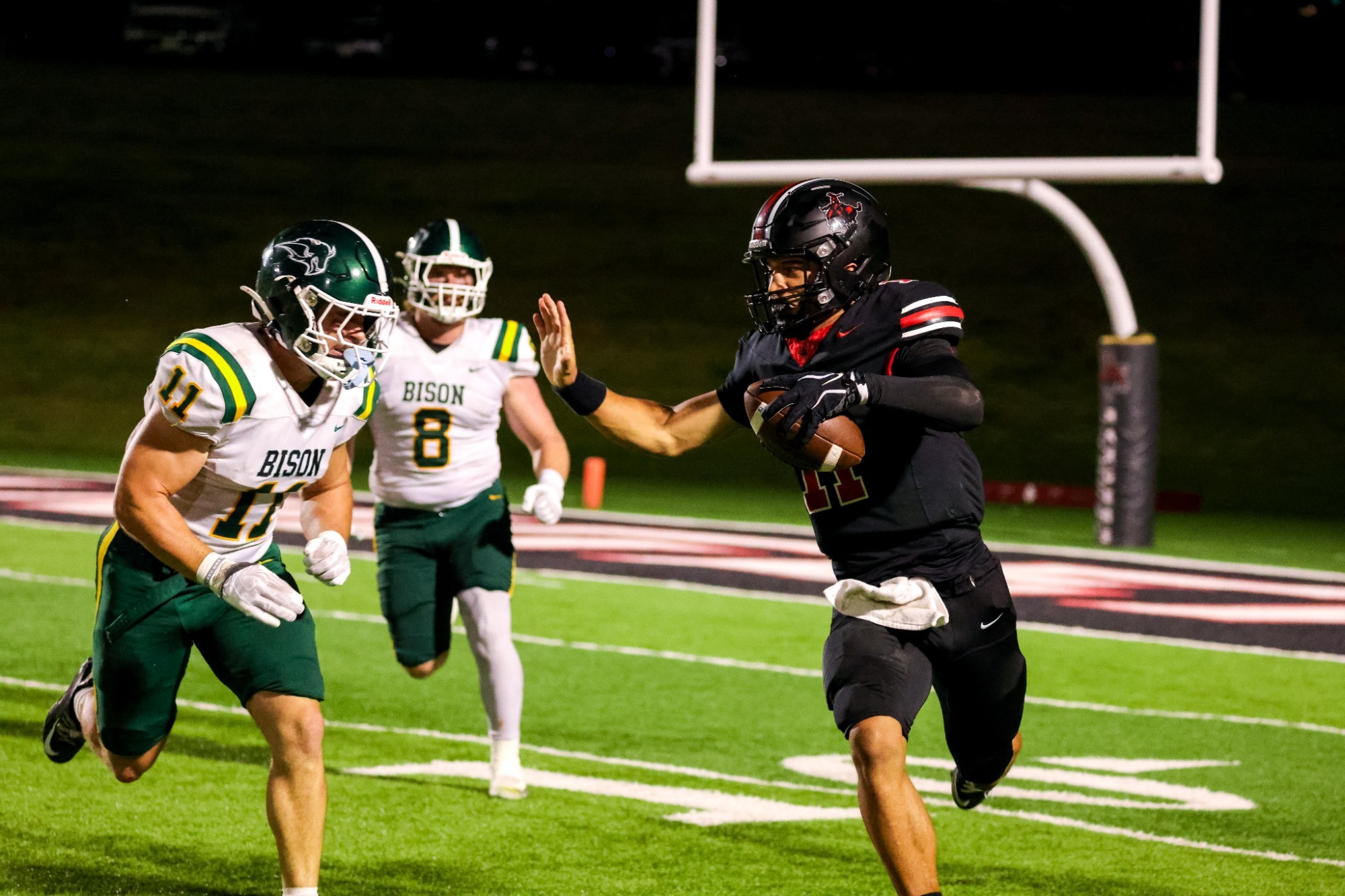 Northwestern football player running a football