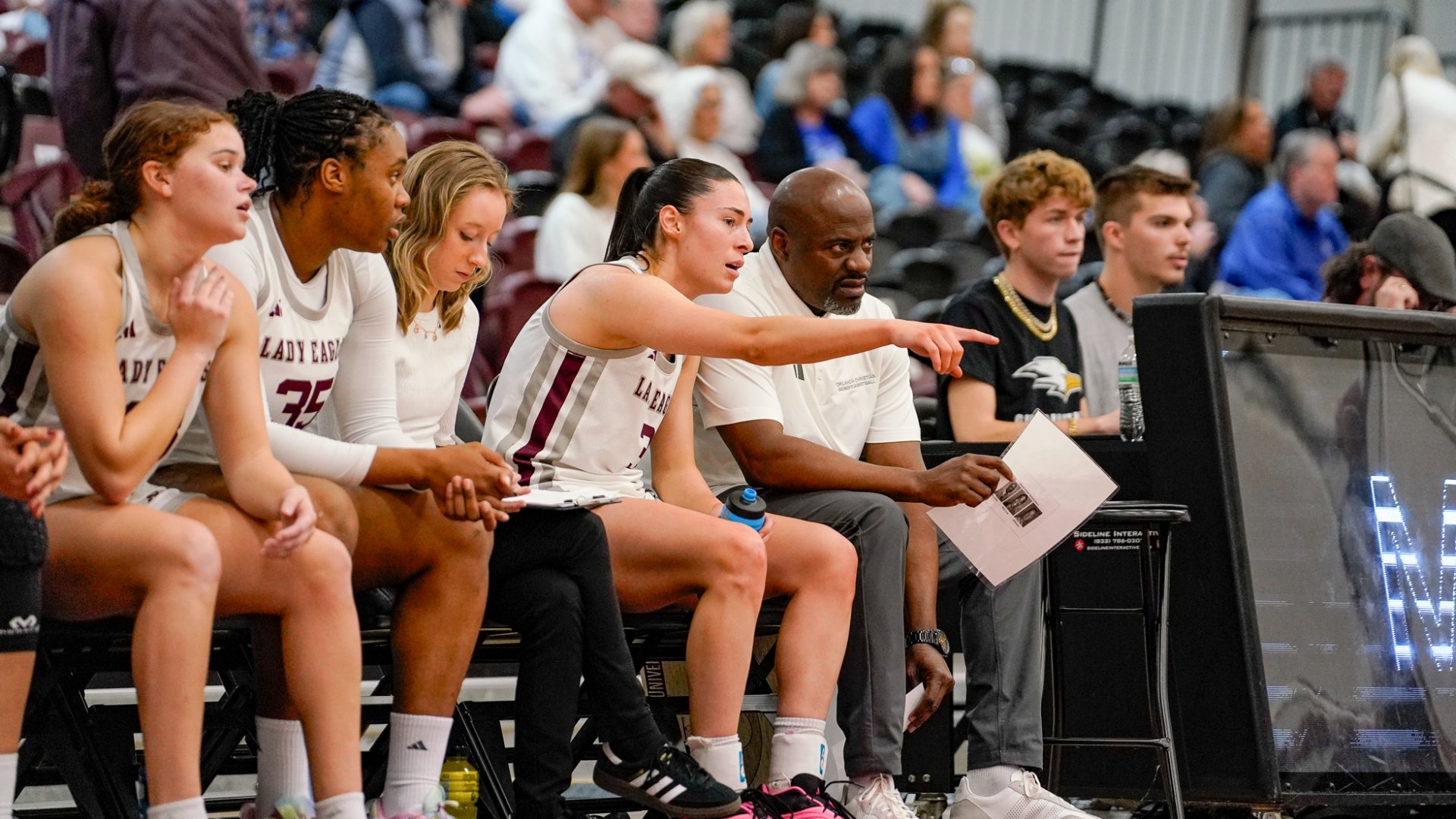 Bennett talking with Coach Lewis on bench