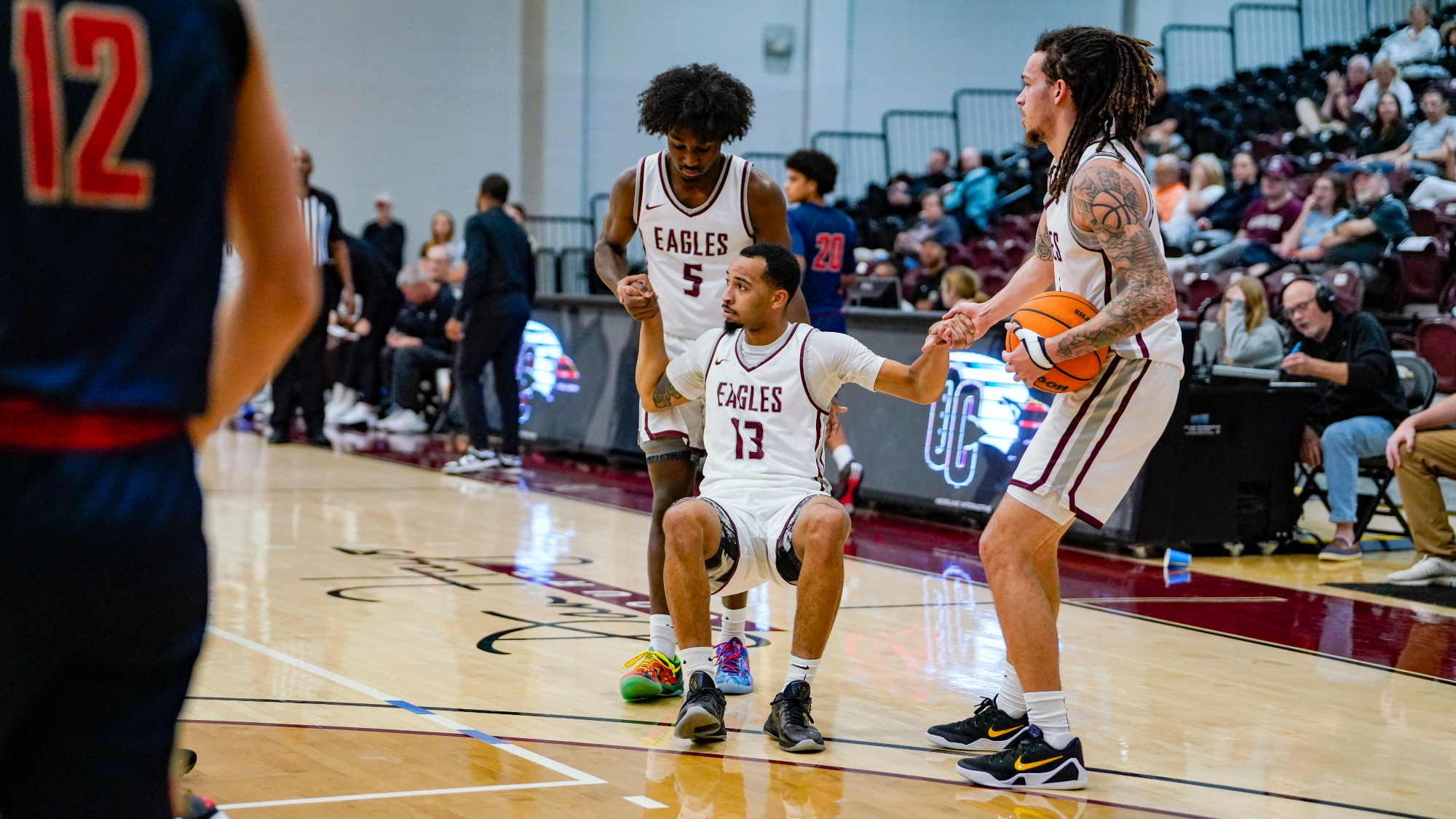 Anderson and Ignowski lift Howell off the floor after getting fouled on the shot.