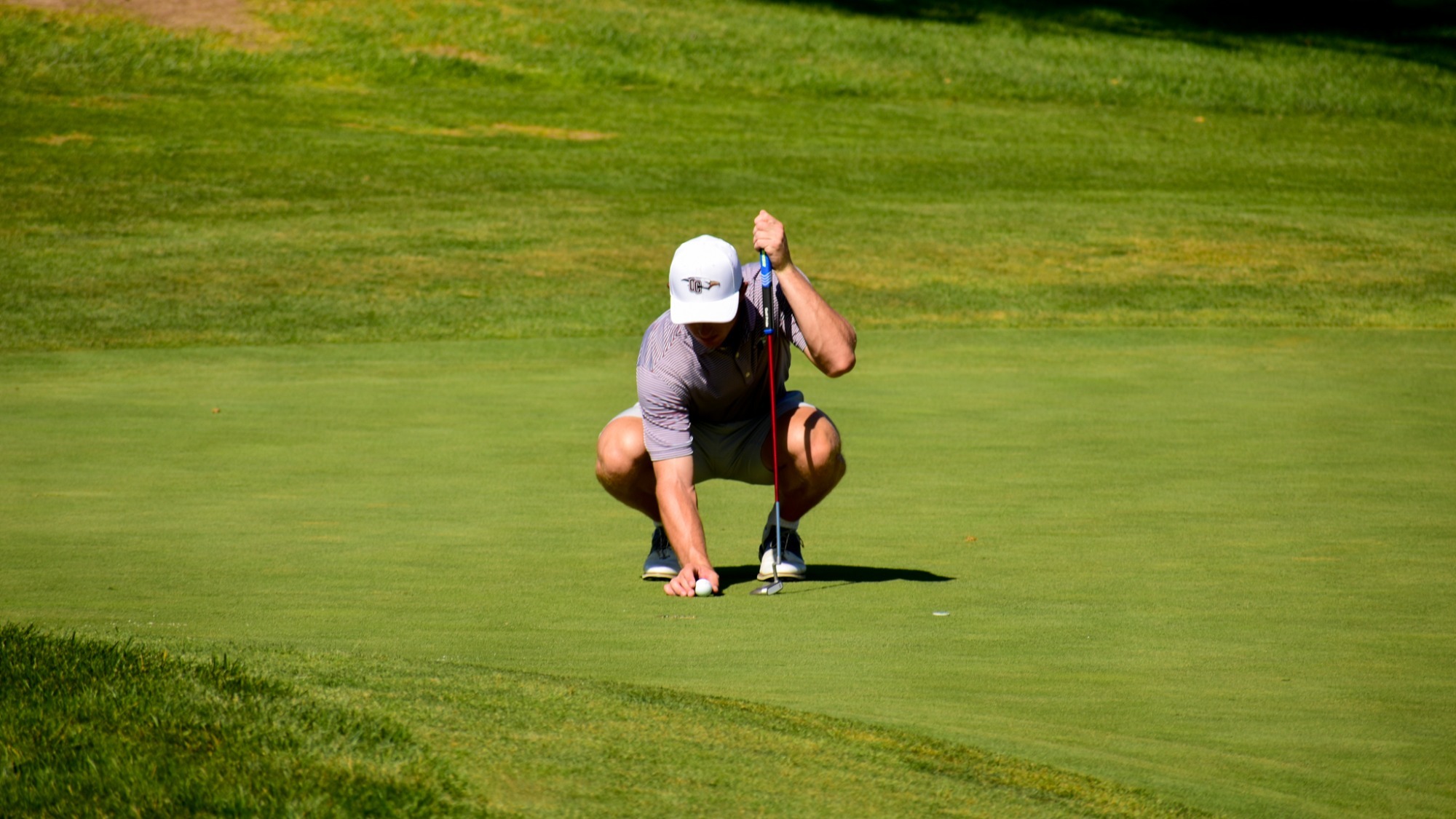 Christian Yanovitch lines up a putt on a green at the Amarillo Country Club