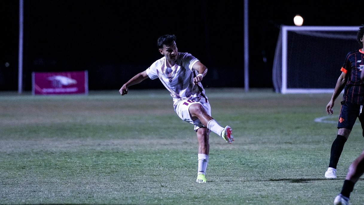 Luis Alvis Fires a Shot on Goal in the 2026 Season, wearing a white uniform with a chevron maroon pattern