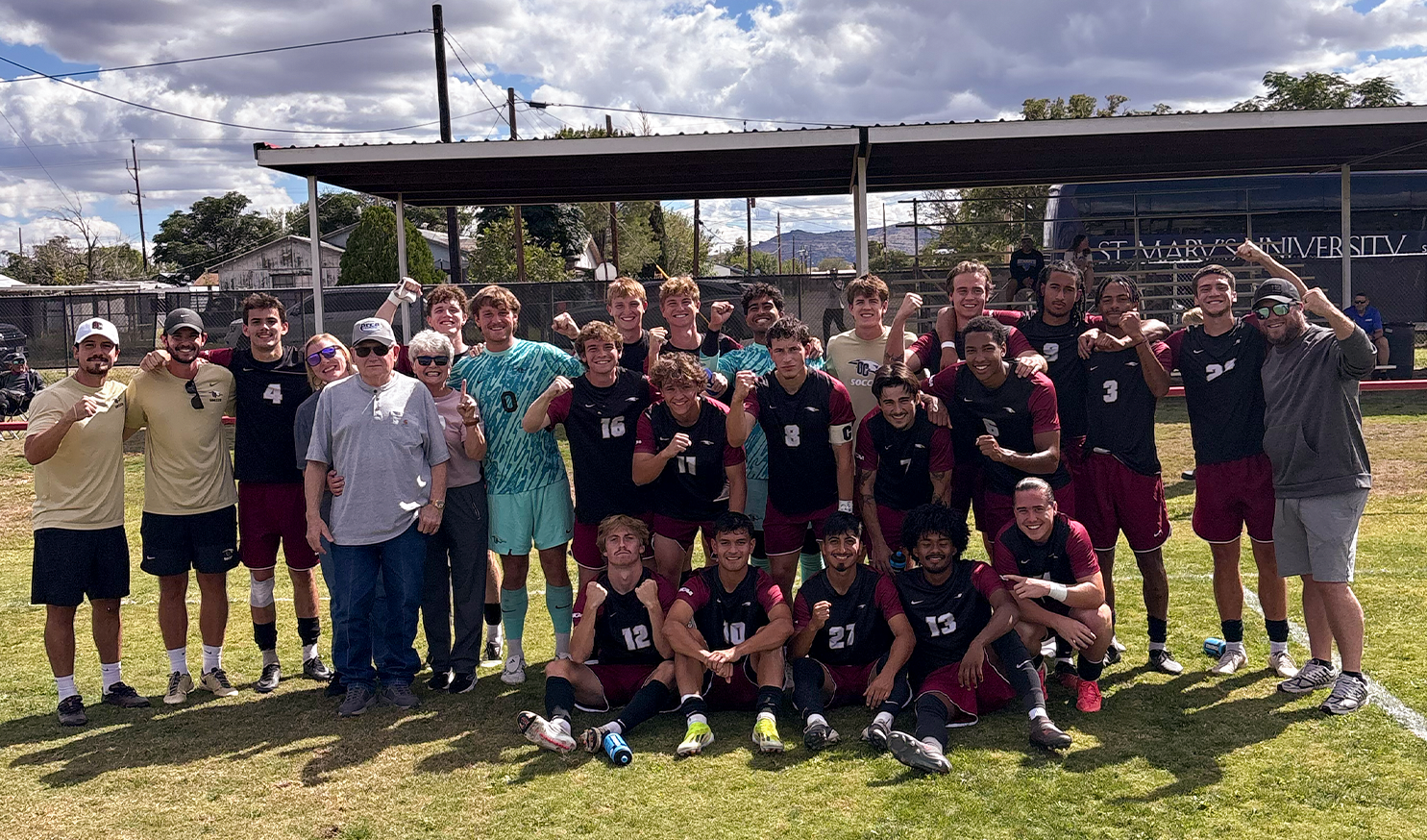 Men's Soccer travel roster poses for photo on field at Sul Roster after victory
