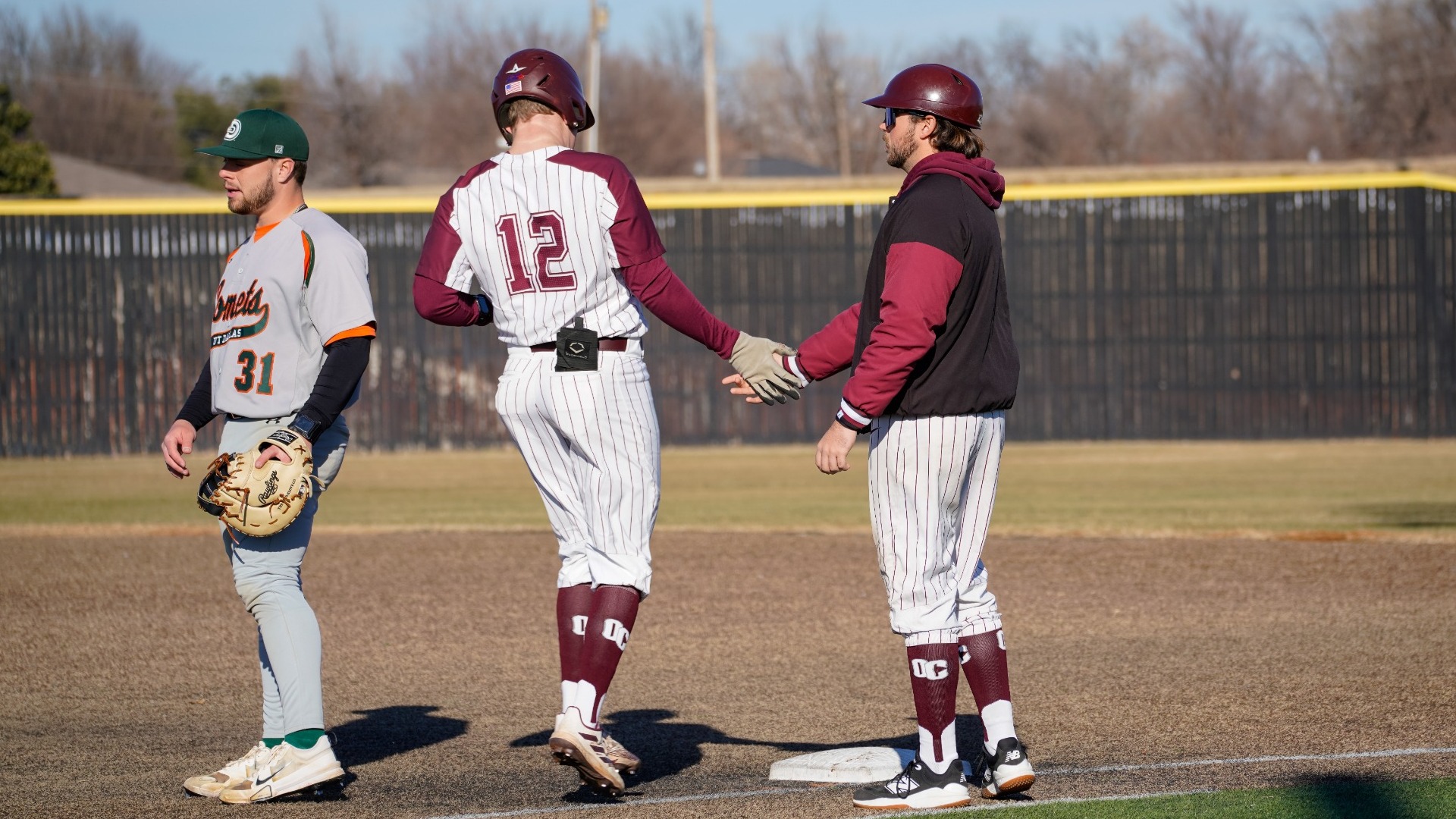 Migl high-fiving first-base coach