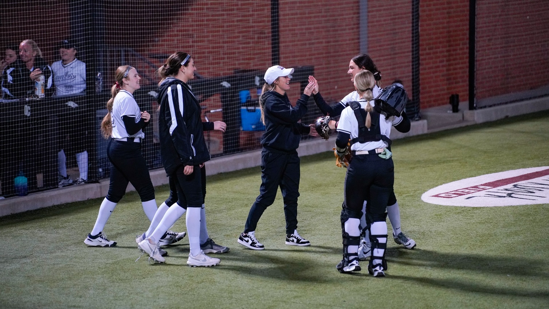Dickson coming off the field, high-fiving coach Rodriguez