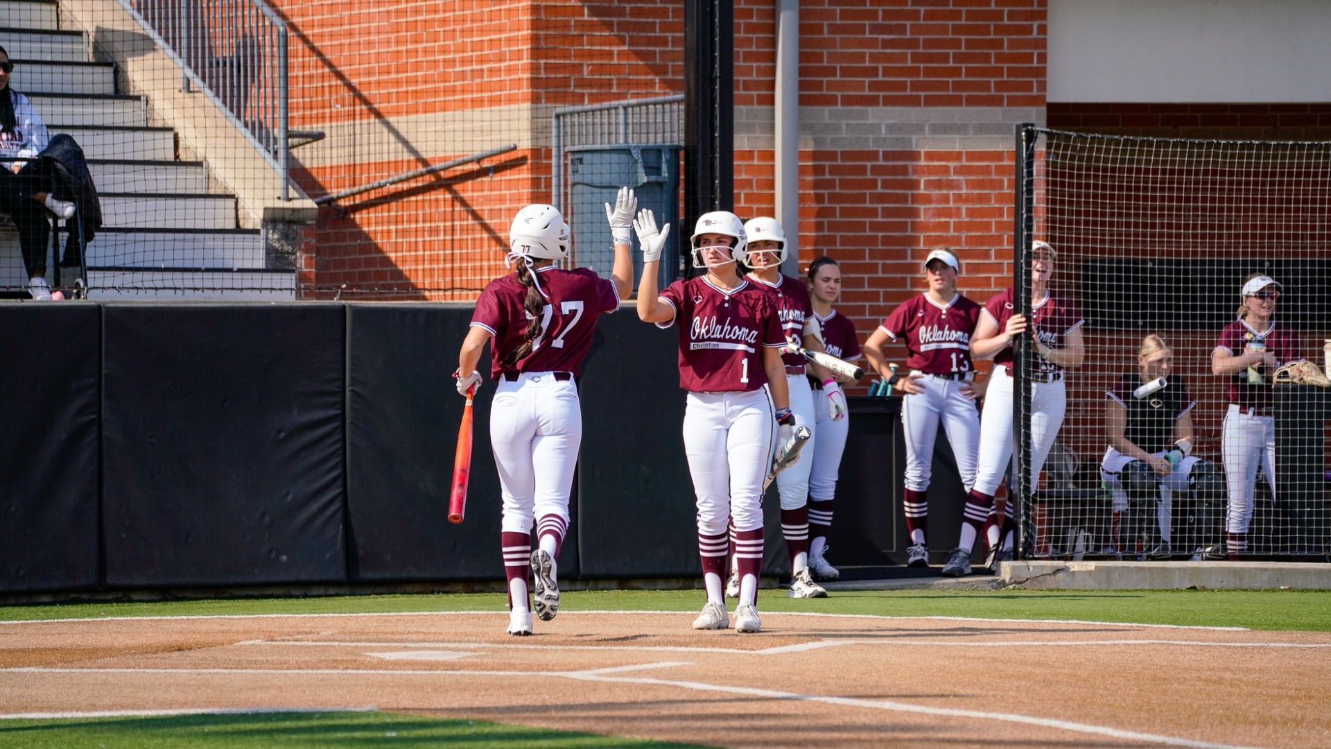 Brewster twins high-fiving at the plate