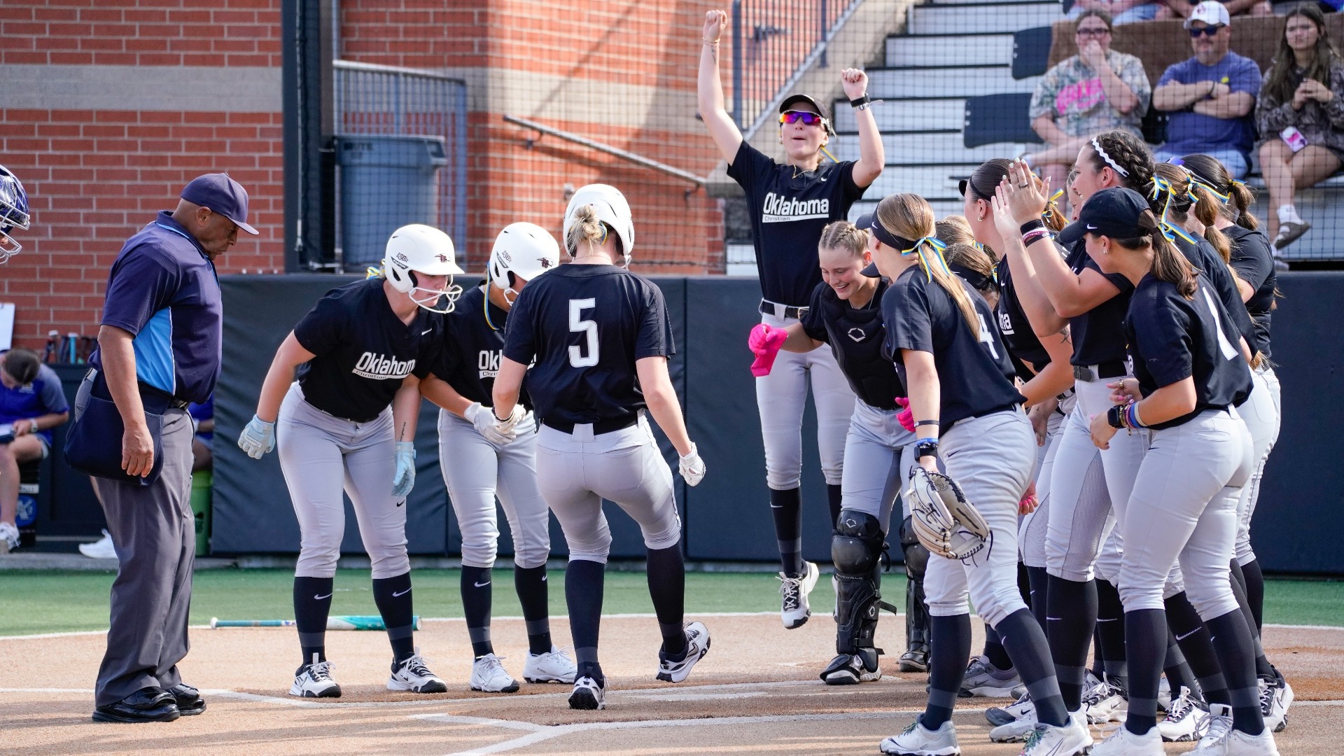 Kallie Rupp touching home plate after home run