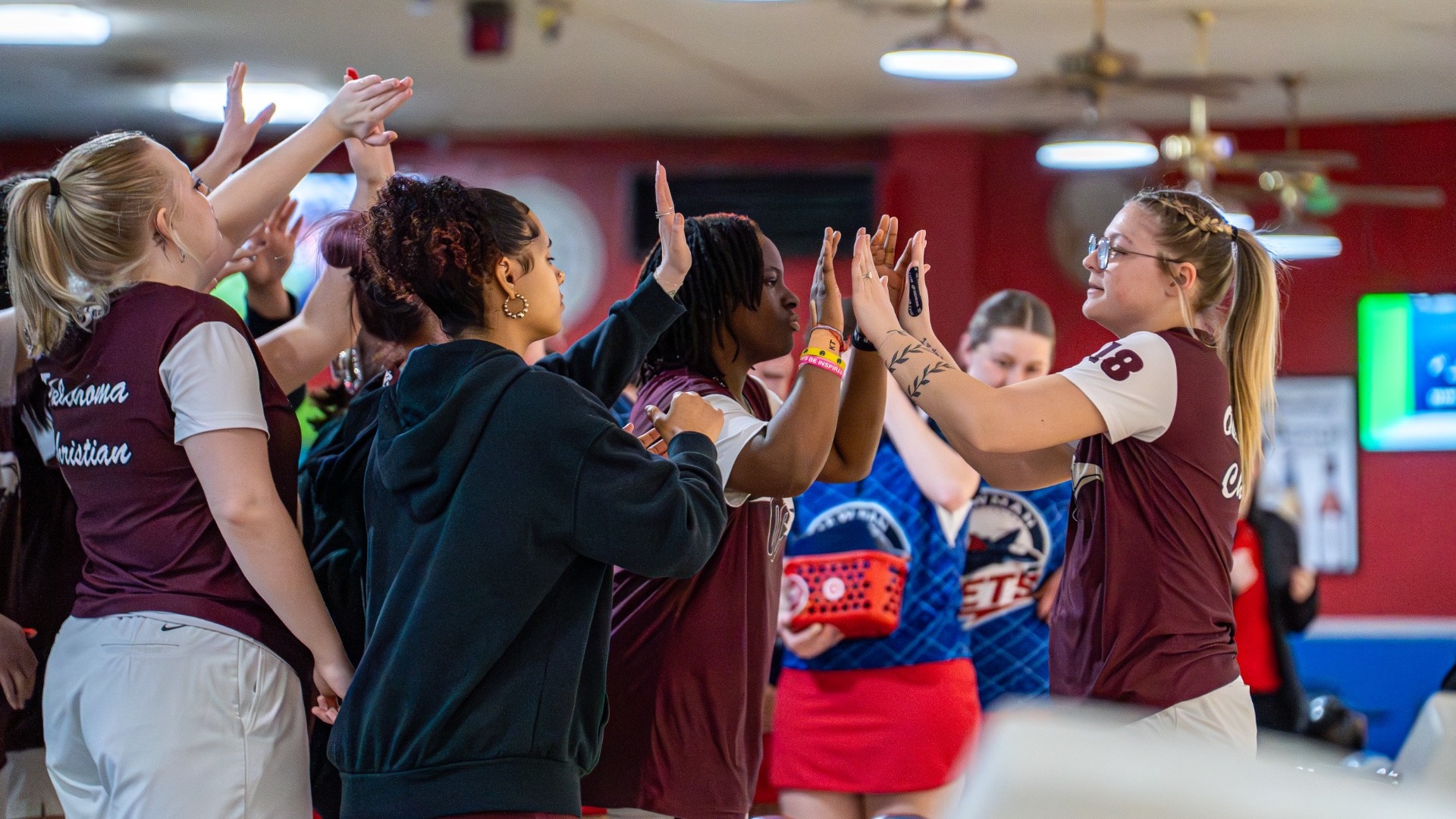 Tori Justice high-fiving team
