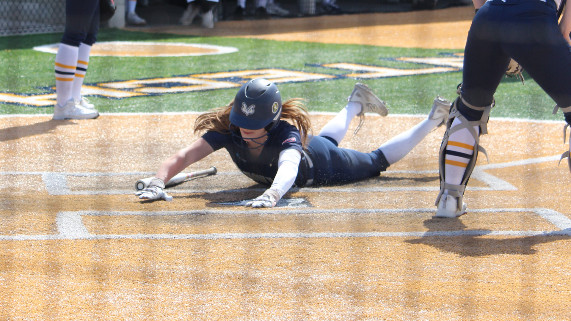 Leah Huffman slides head first at home plate