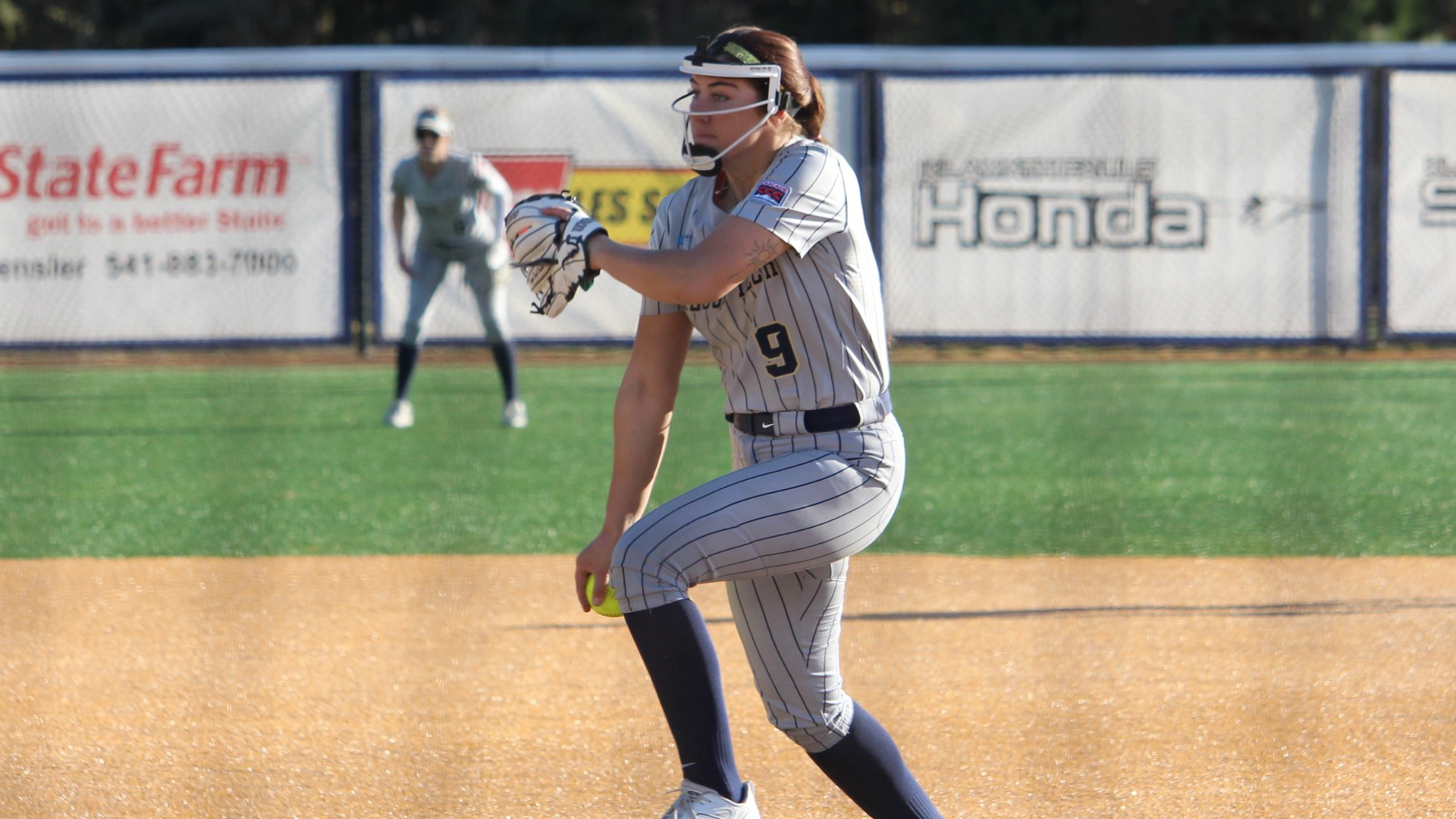 Alli Parker throwing a pitch vs. Corban