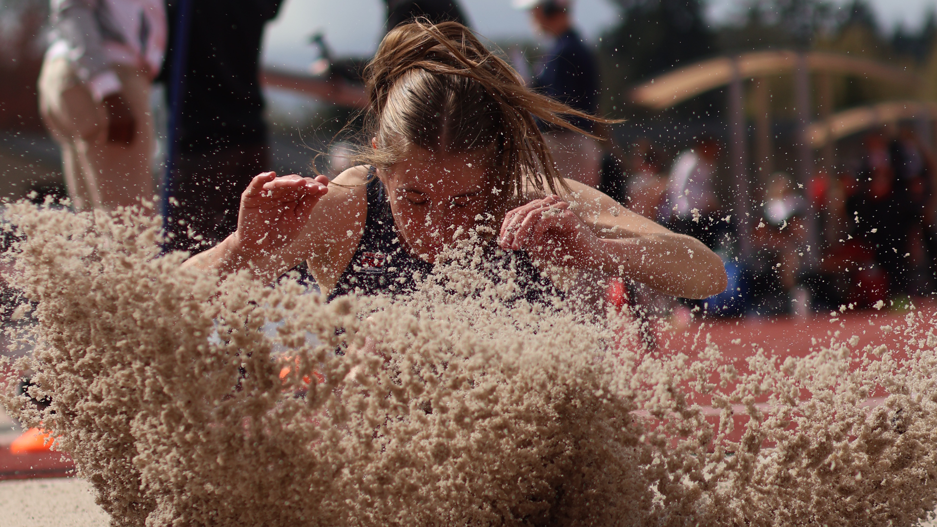 Sydney Soskis landing in long jump pit