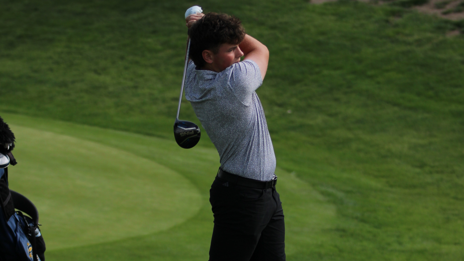 Silas Guzlas hitting an iron at CCC Tourney