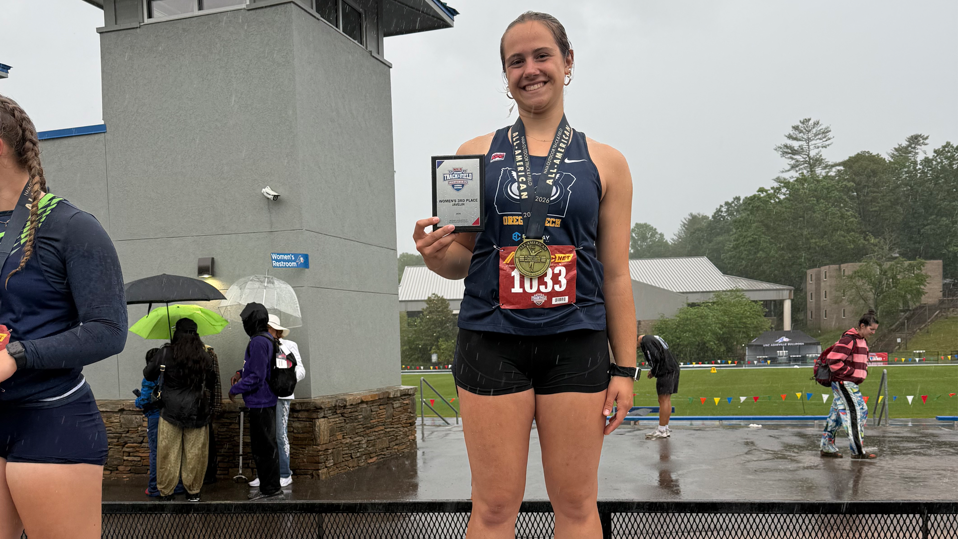 Amina Redfield with All-America trophy