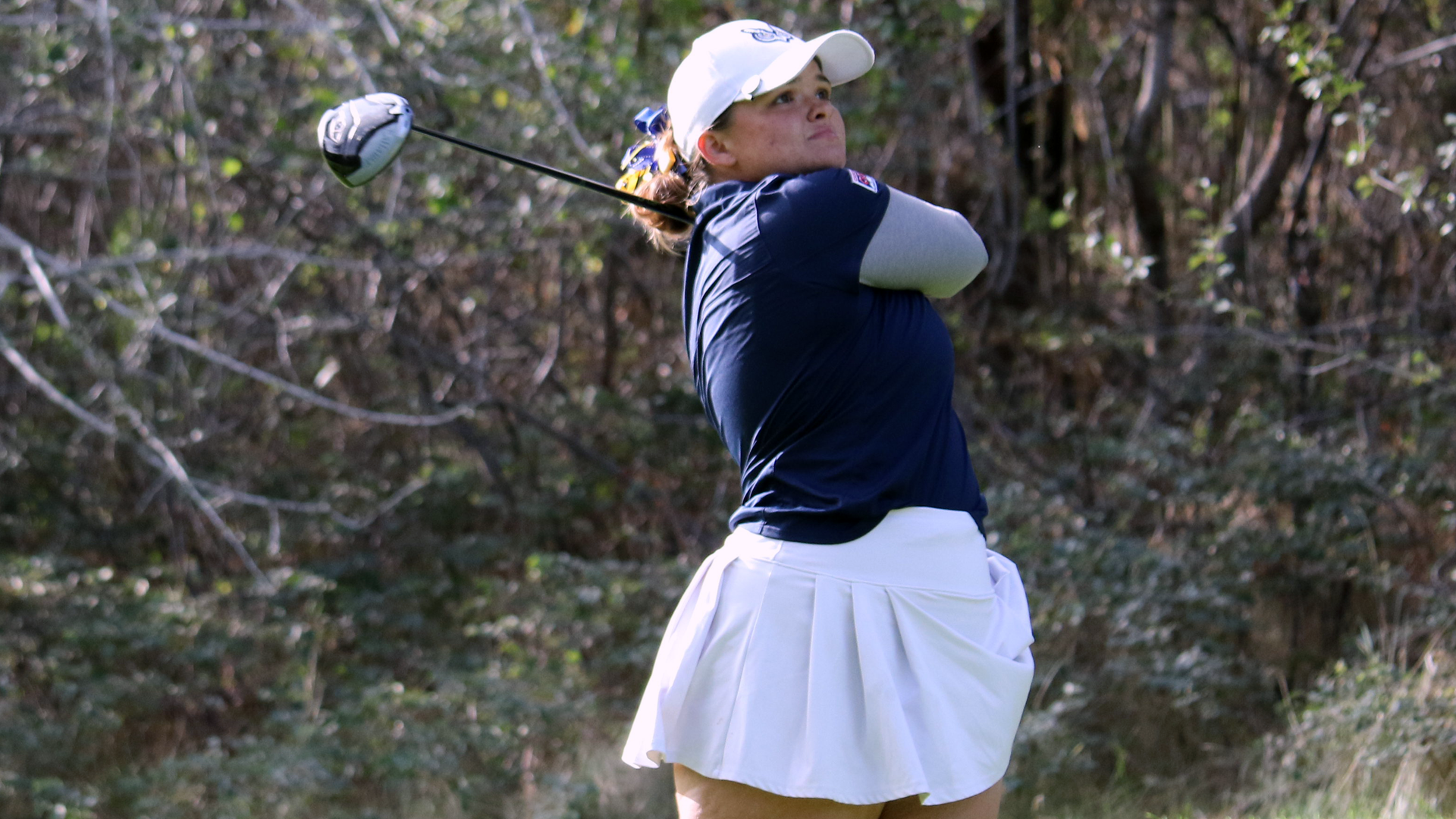 Sydney Dick swinging a golf club