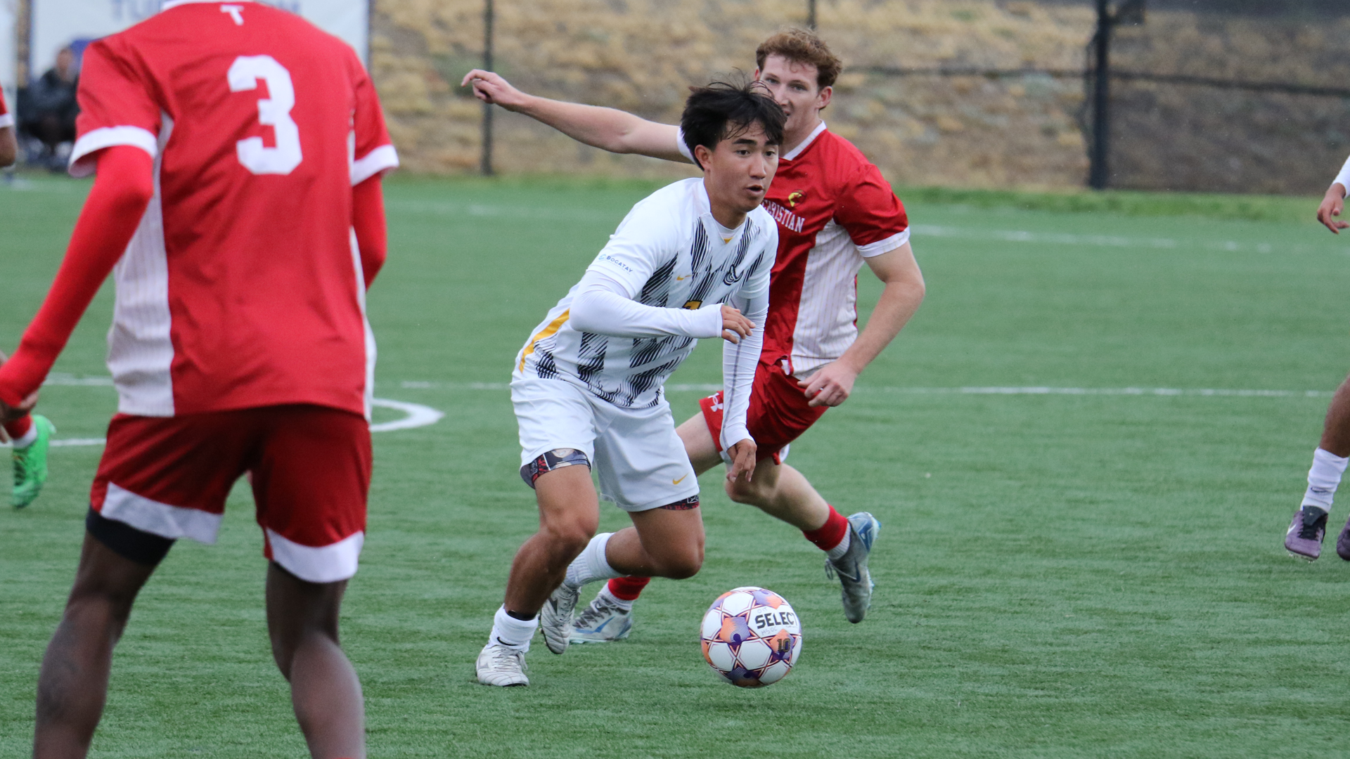 Soccer Players eluding defenders