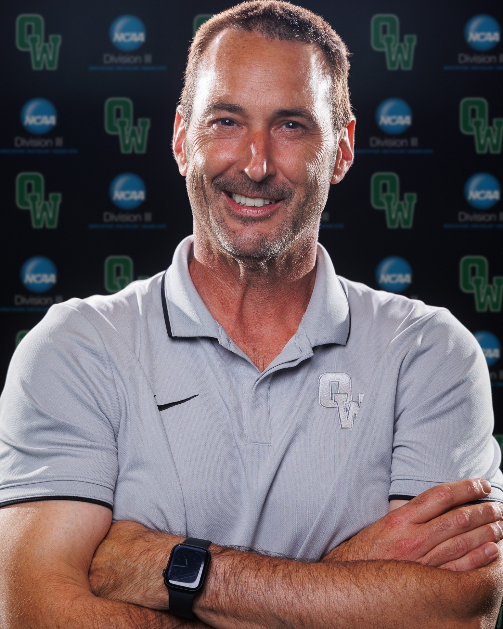 Coach Chris McCoy with arms folded