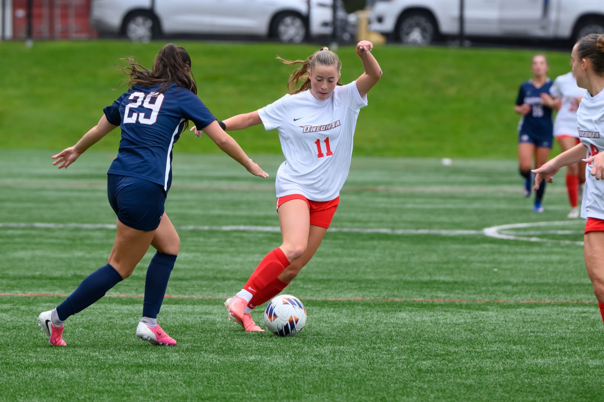 Violet Mattoni dribbles by a Eastern Connecticut State defender