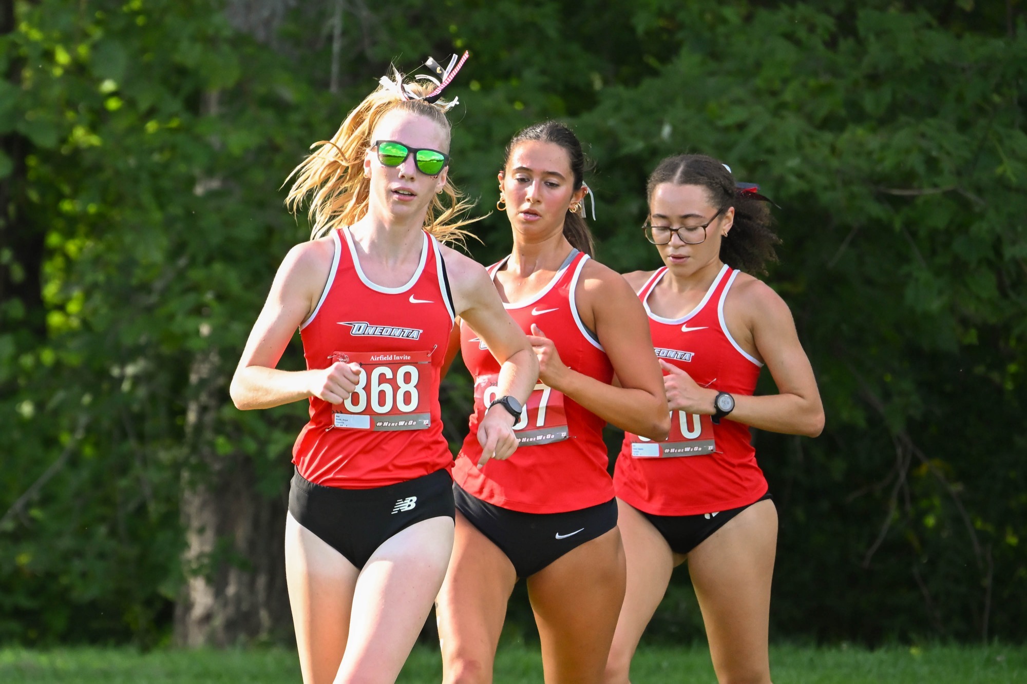 Anya Sloth runs in front of Jill Cinquina and Natalia Sweat at Oneonta Airfield Invitational