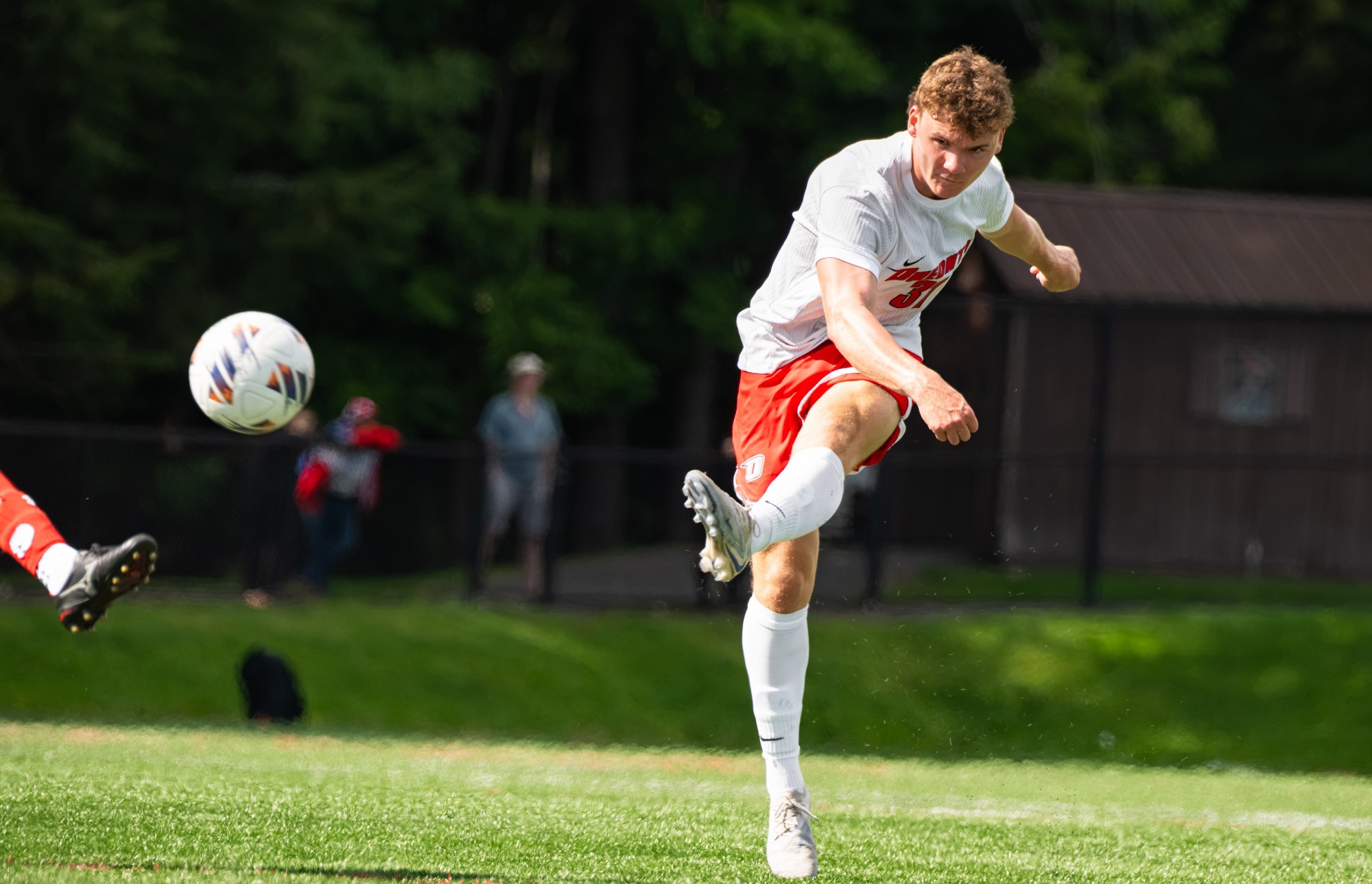 Drew Lennon fires the ball into the penalty box against King's College