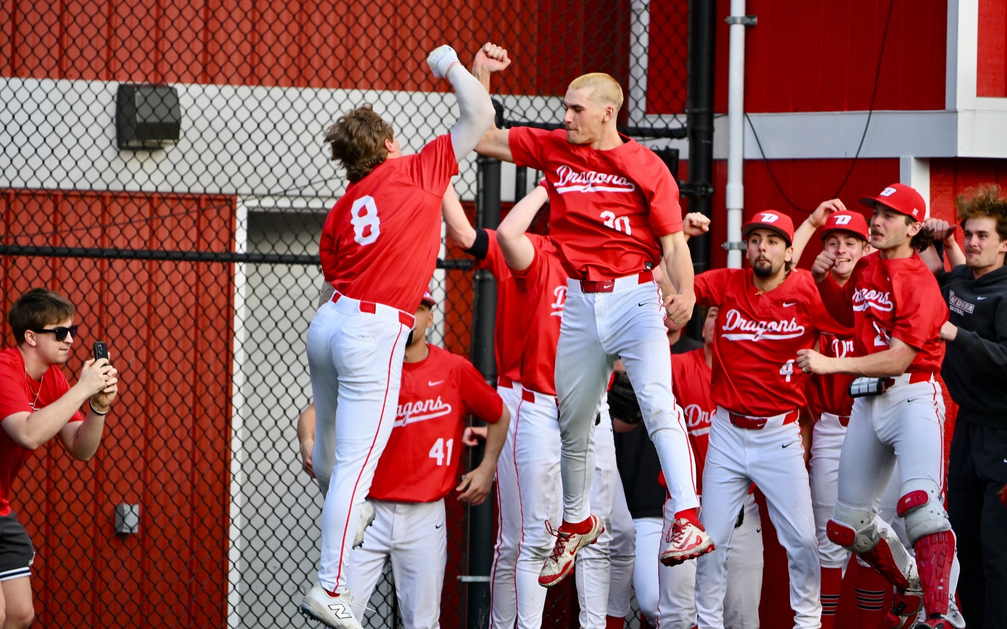 Nick Jacoby celebrates with team after hitting a home run