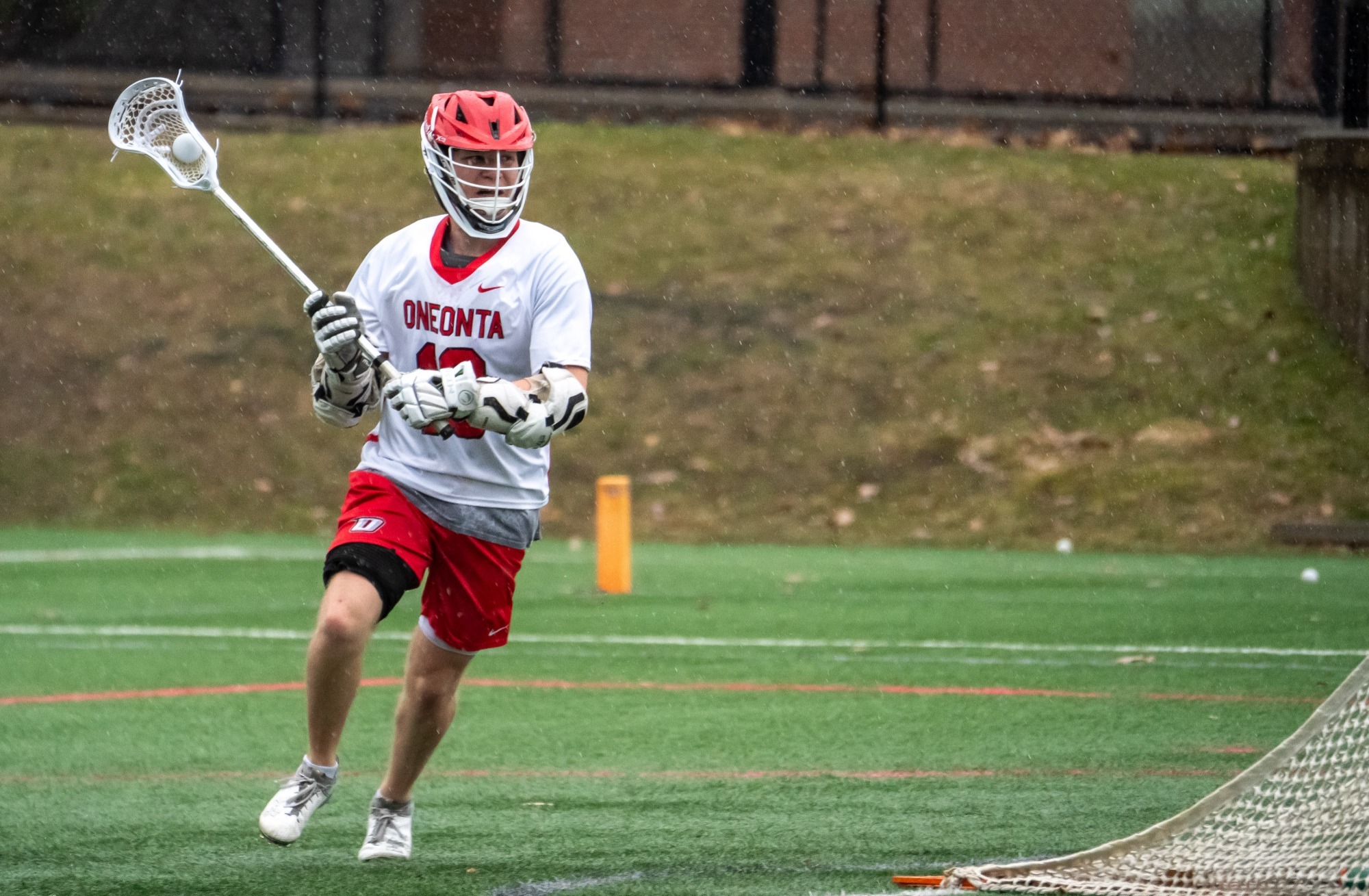 Aidan Boyle bringing the ball behind the net against Hartwick